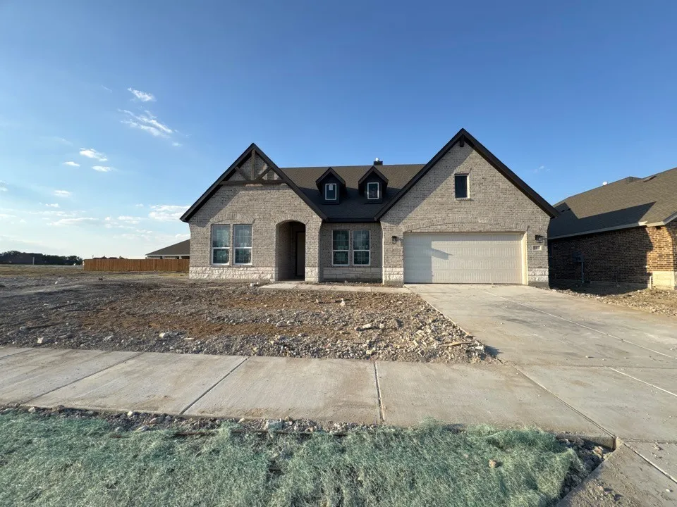 Brick exterior with stone accents and dark trim