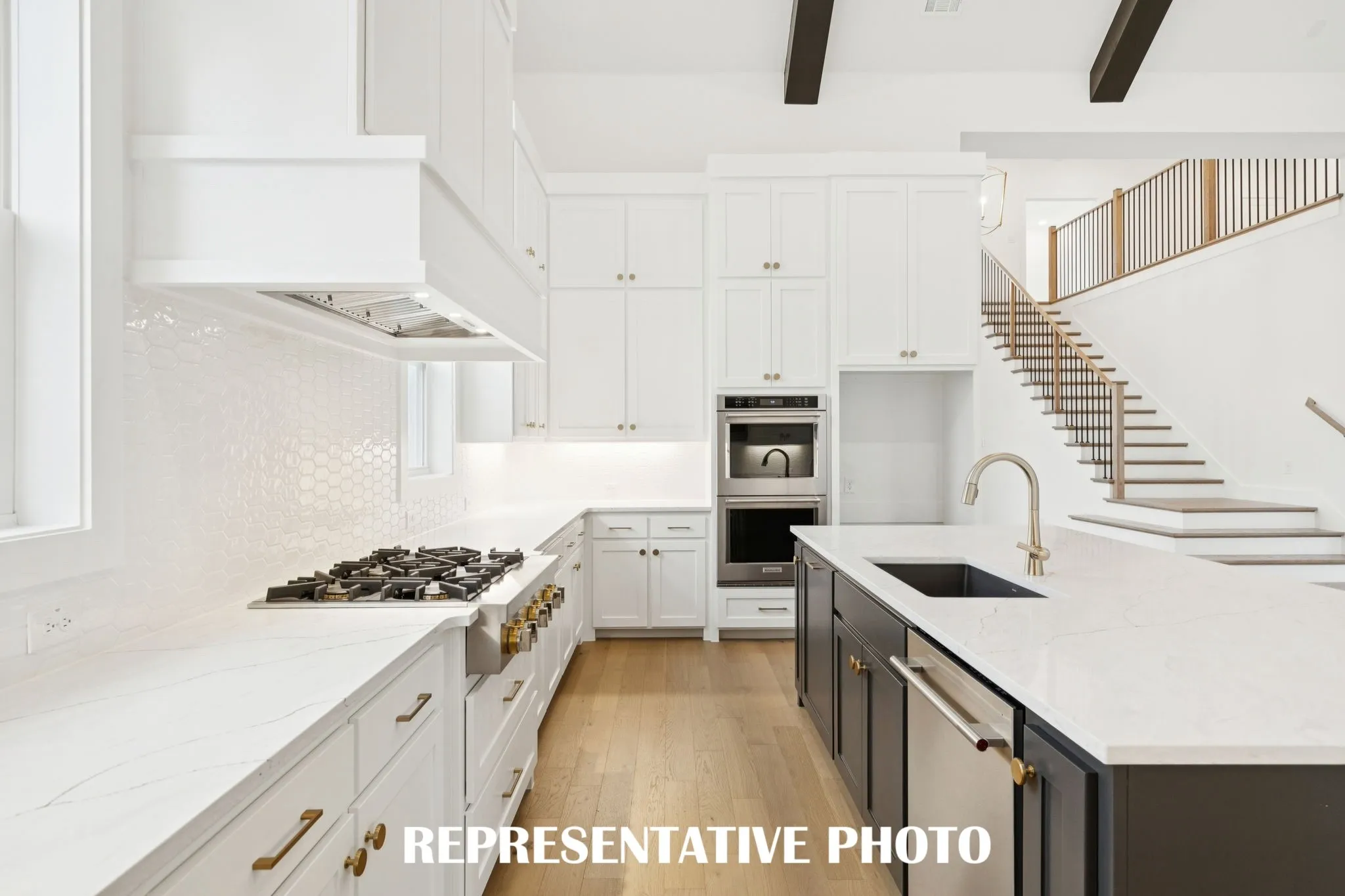 Beautiful cabinetry, gorgeous countertops and elegant backsplash effortlessly pair with contemporary stainless steel to create a kitchen for the ages!  REPRESENTATIVE PHOTO