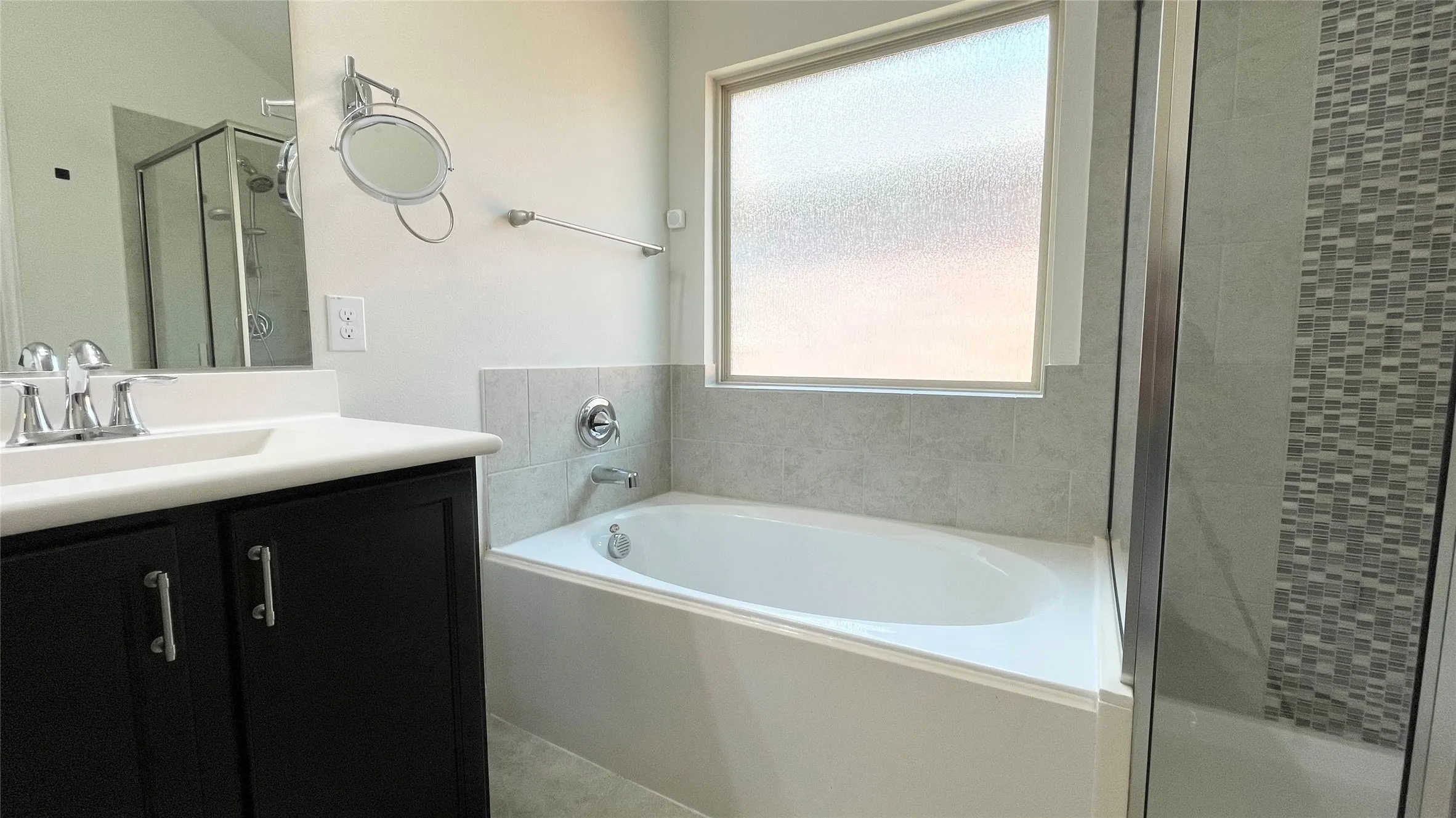 White countertop vanity with dark wood-finish cabinetry