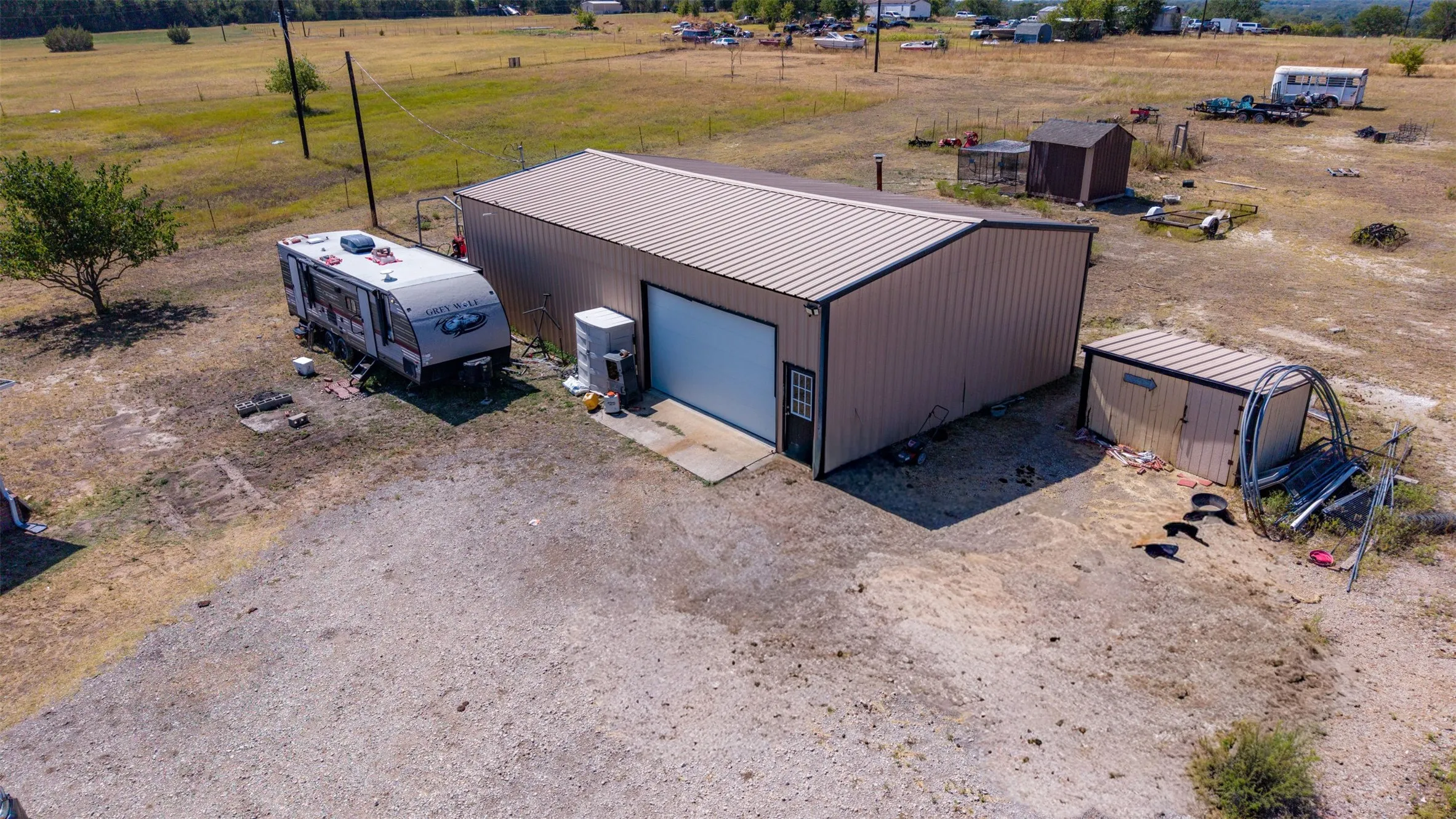 Metal building with a roll-up door, side entry door, and corrugated metal roofing