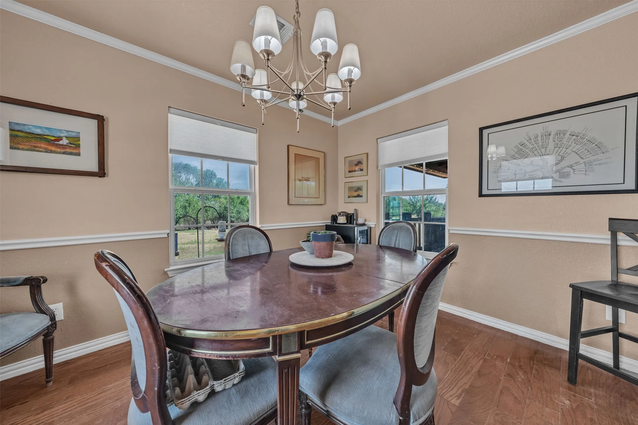 Wood-finish flooring with crown molding and chair rail accents