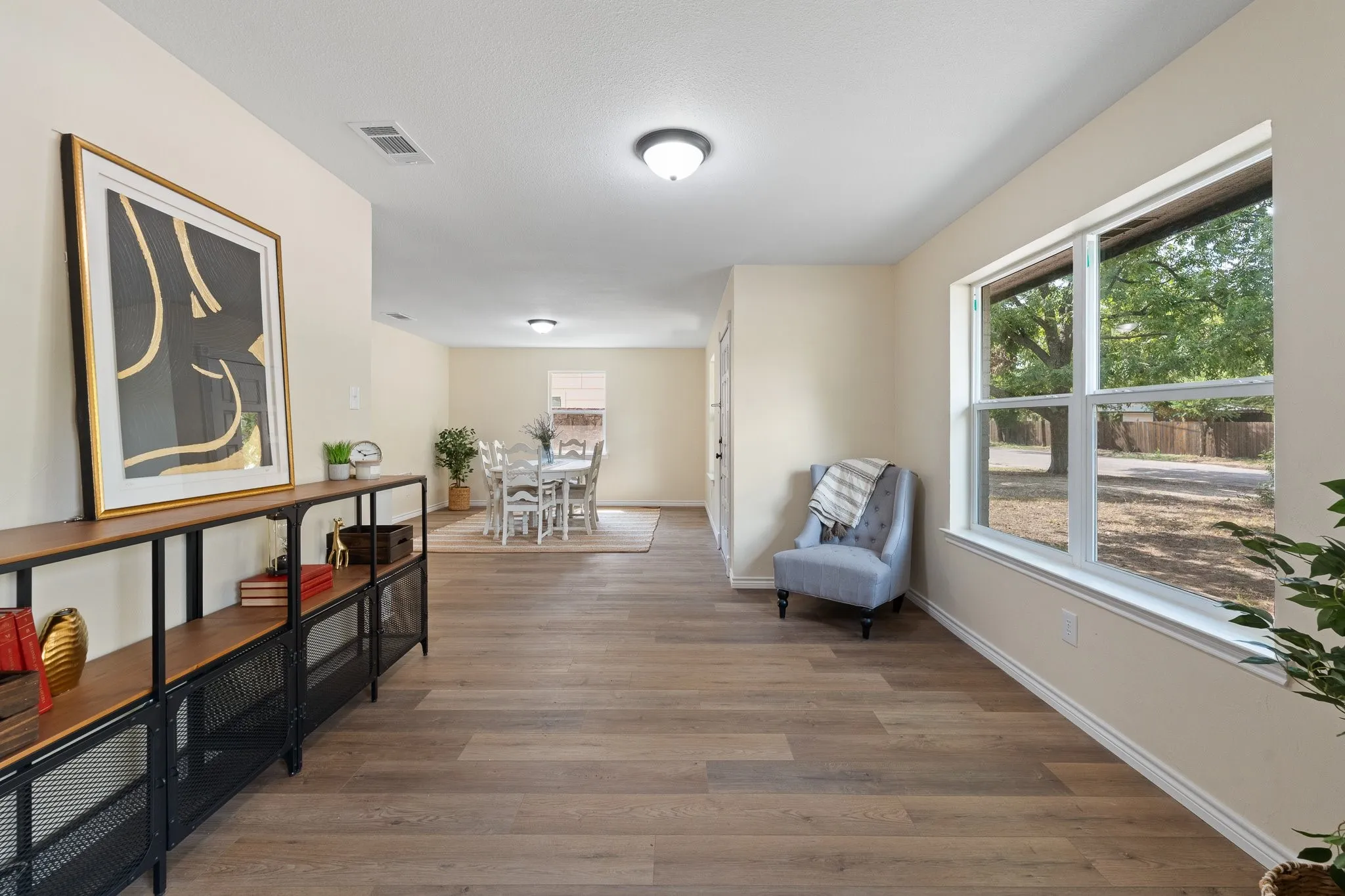 Wood-finish flooring throughout, light neutral wall paint, and recessed lighting