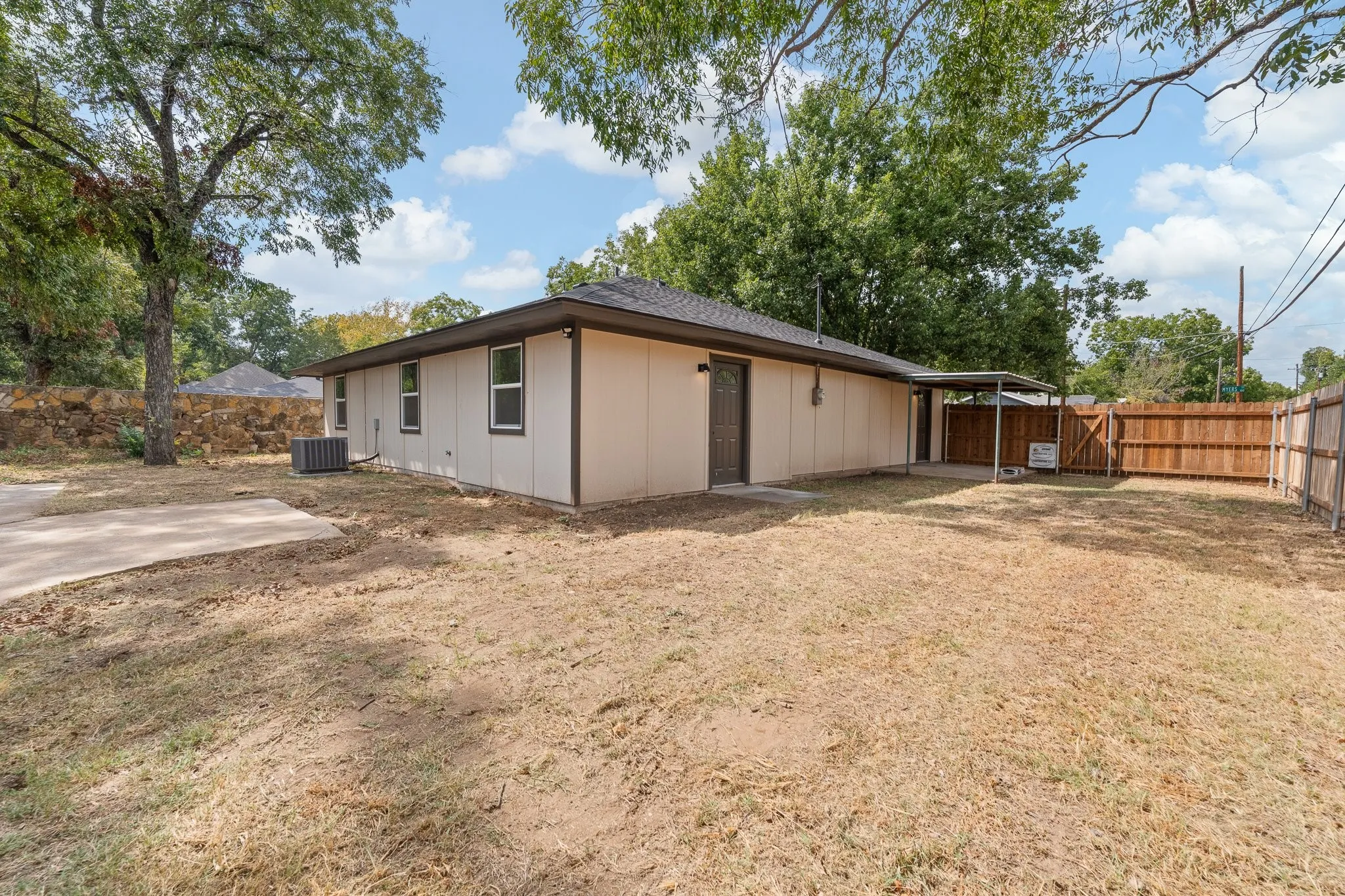 Expansive yard with wood fencing and mature trees