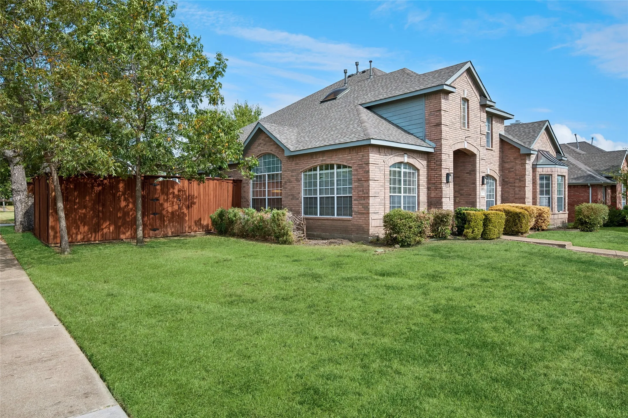 ** ENHANCED GRASS PHOTO**Brick exterior with an arched entryway