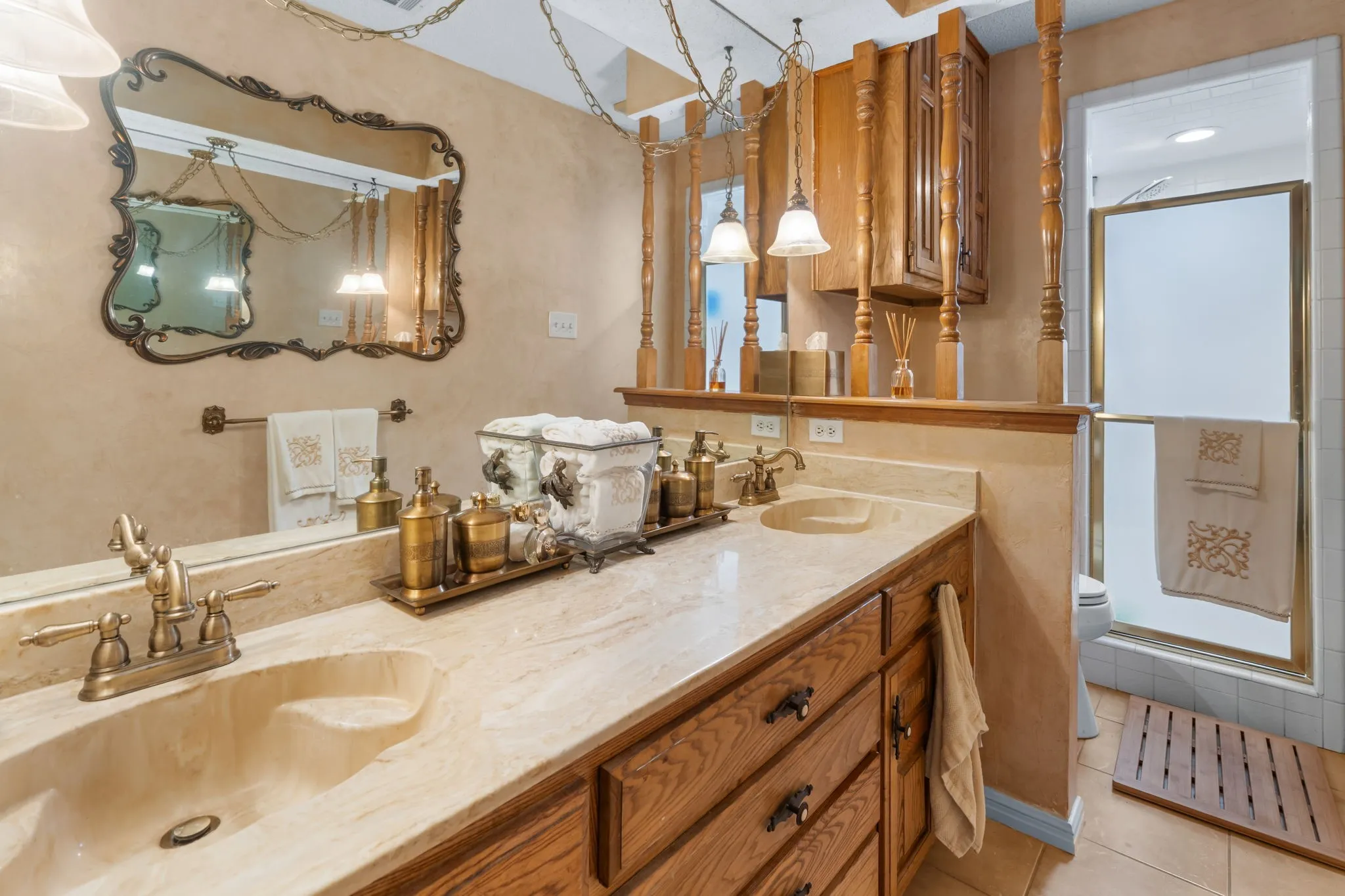 Upstairs Full Bathroom, dual vanity with integrated sinks, wood cabinetry, and a framed mirror