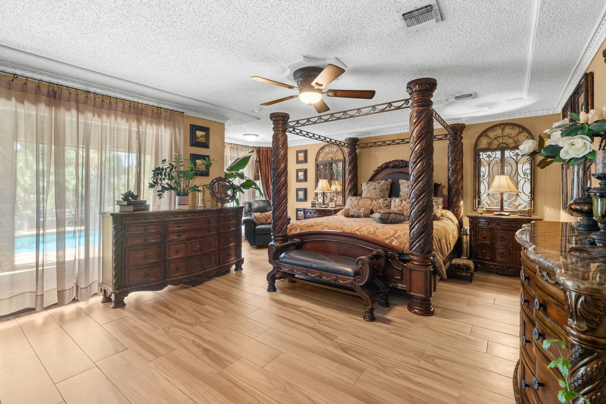 Wood-finish flooring, tray ceiling, ceiling fan, and crown molding. Bottom floor.