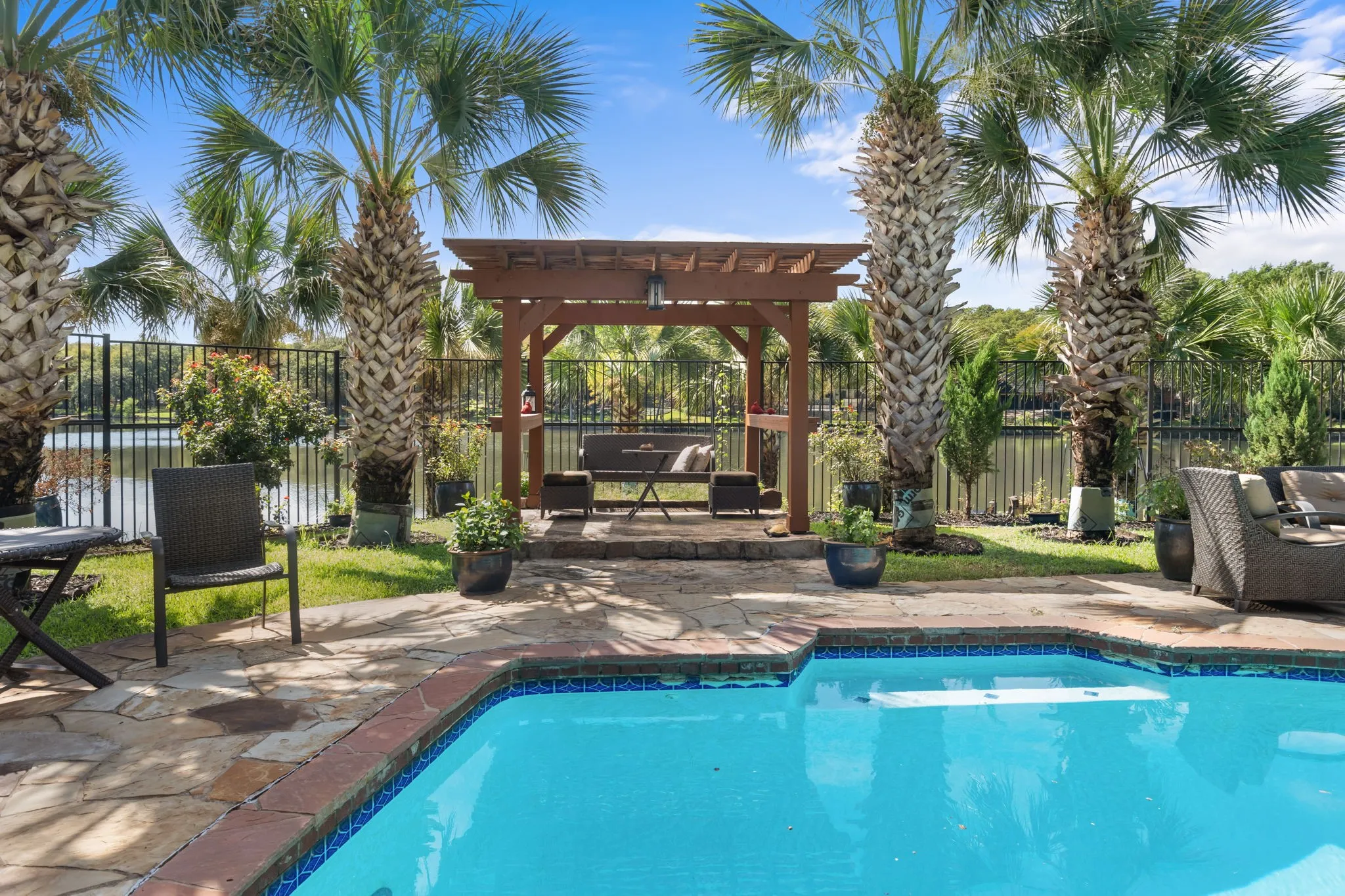 Pergola overlooking pool and lake.