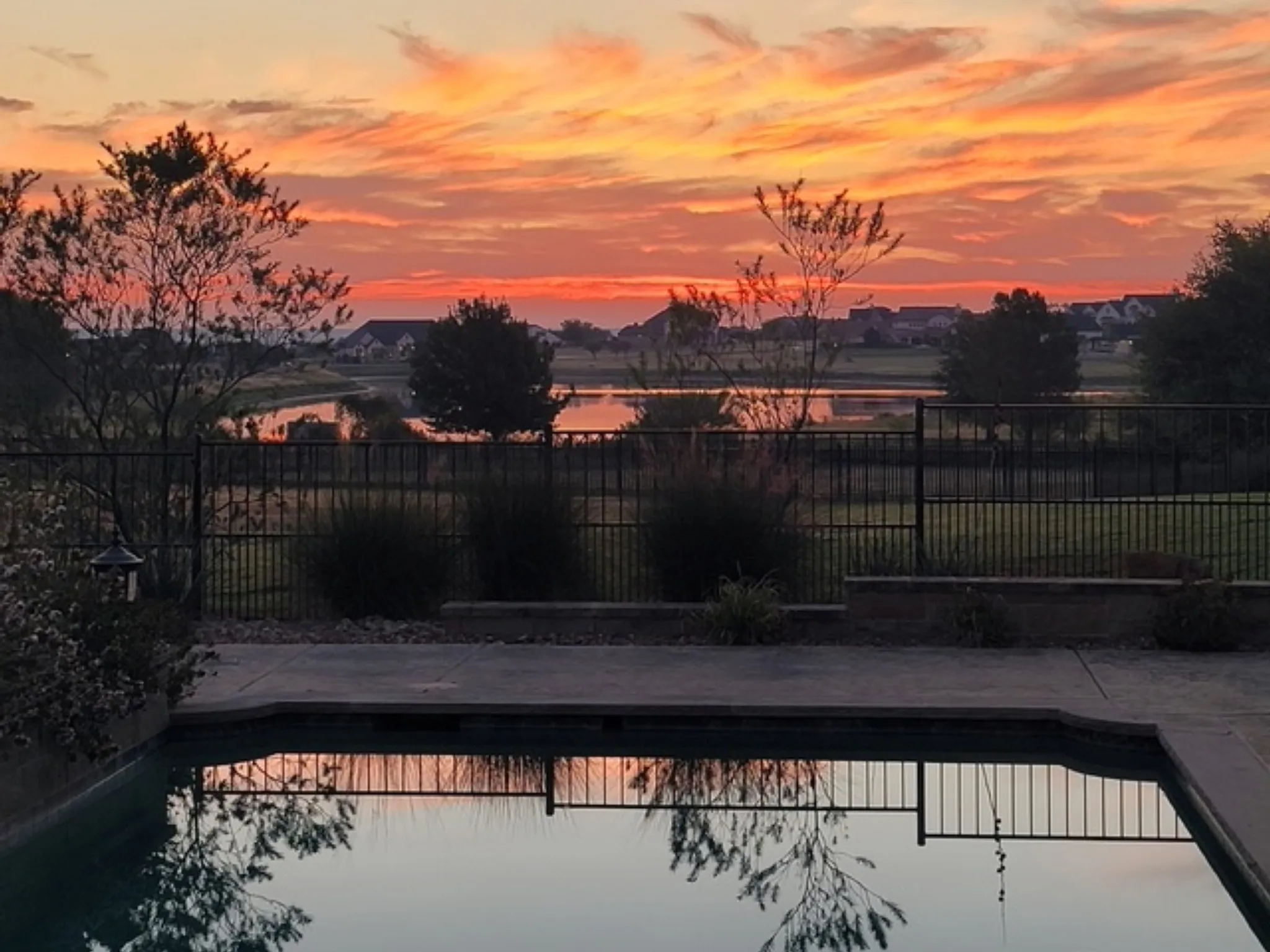At sunset, pool overlooking quiet neighborhood