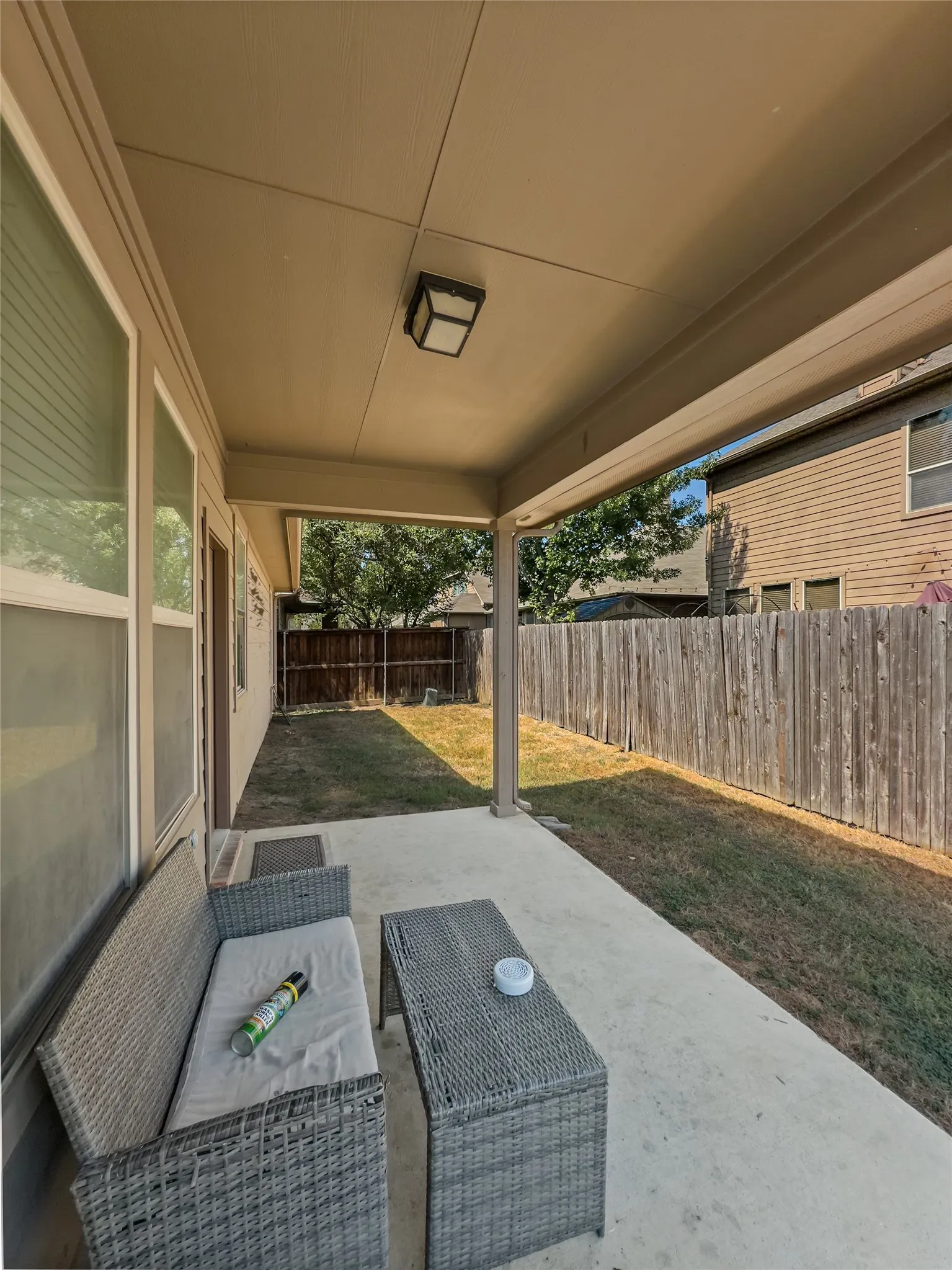 Covered patio with concrete flooring, recessed lighting, and a fenced backyard