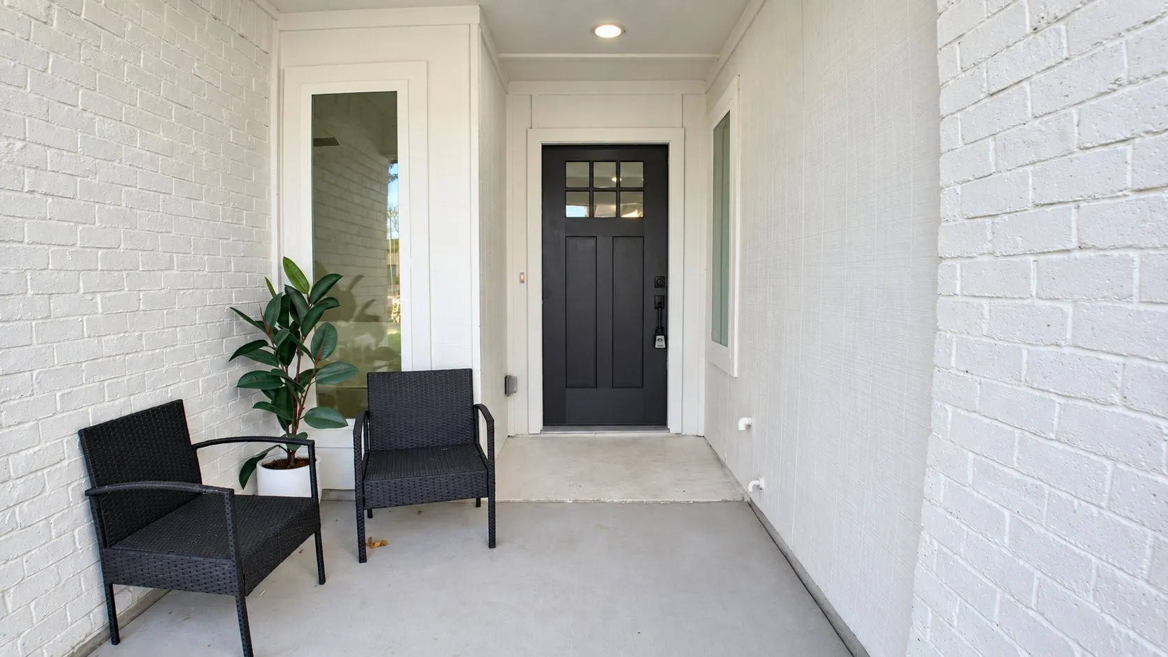 Covered entry with painted brick exterior