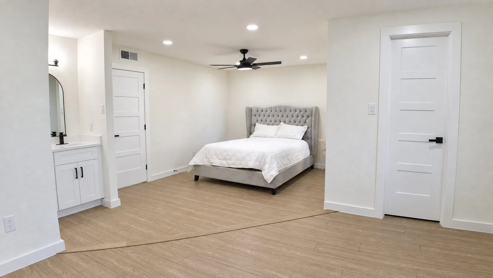 Light-toned wood-finish flooring, recessed lighting, and a ceiling fan with integrated light