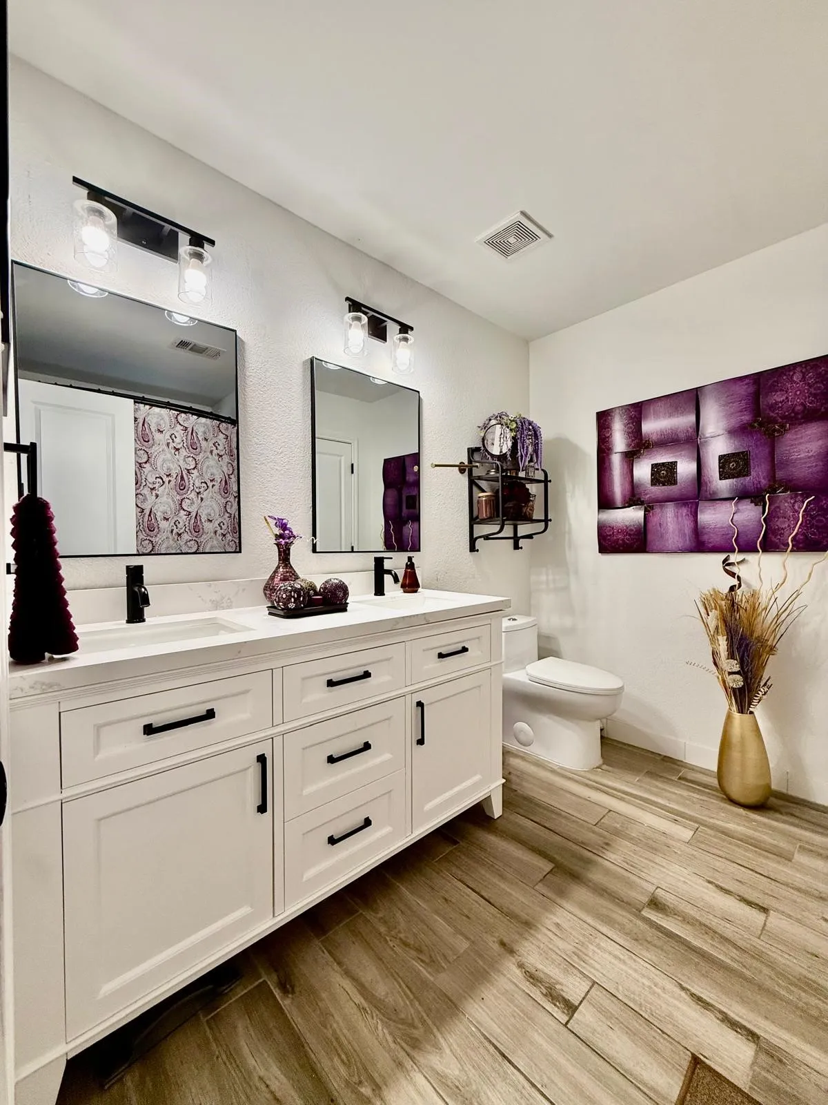 Dual vanity with white cabinetry and black hardware