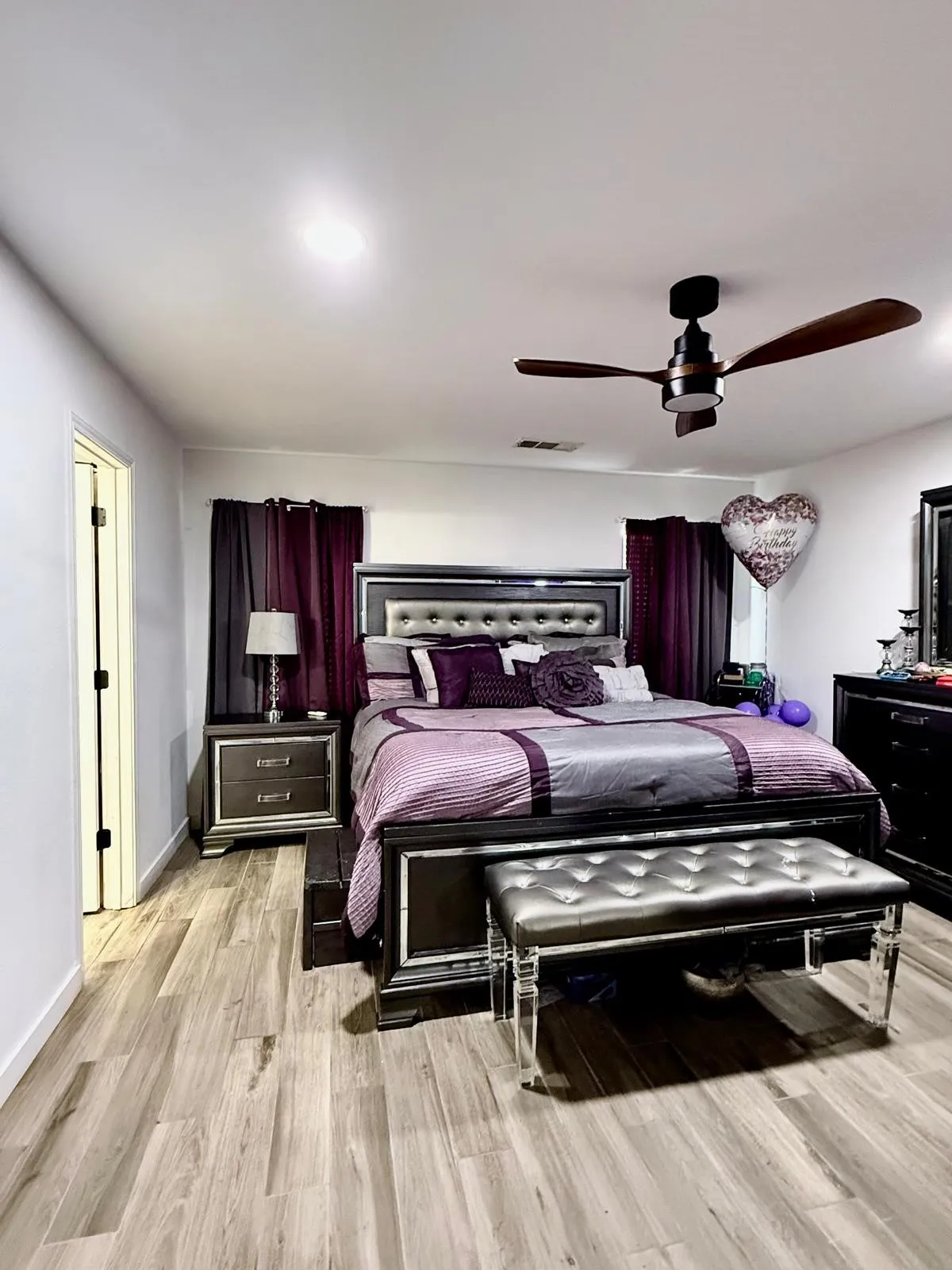 Recessed ceiling lighting, wood-finish flooring, and a ceiling fan with integrated lighting