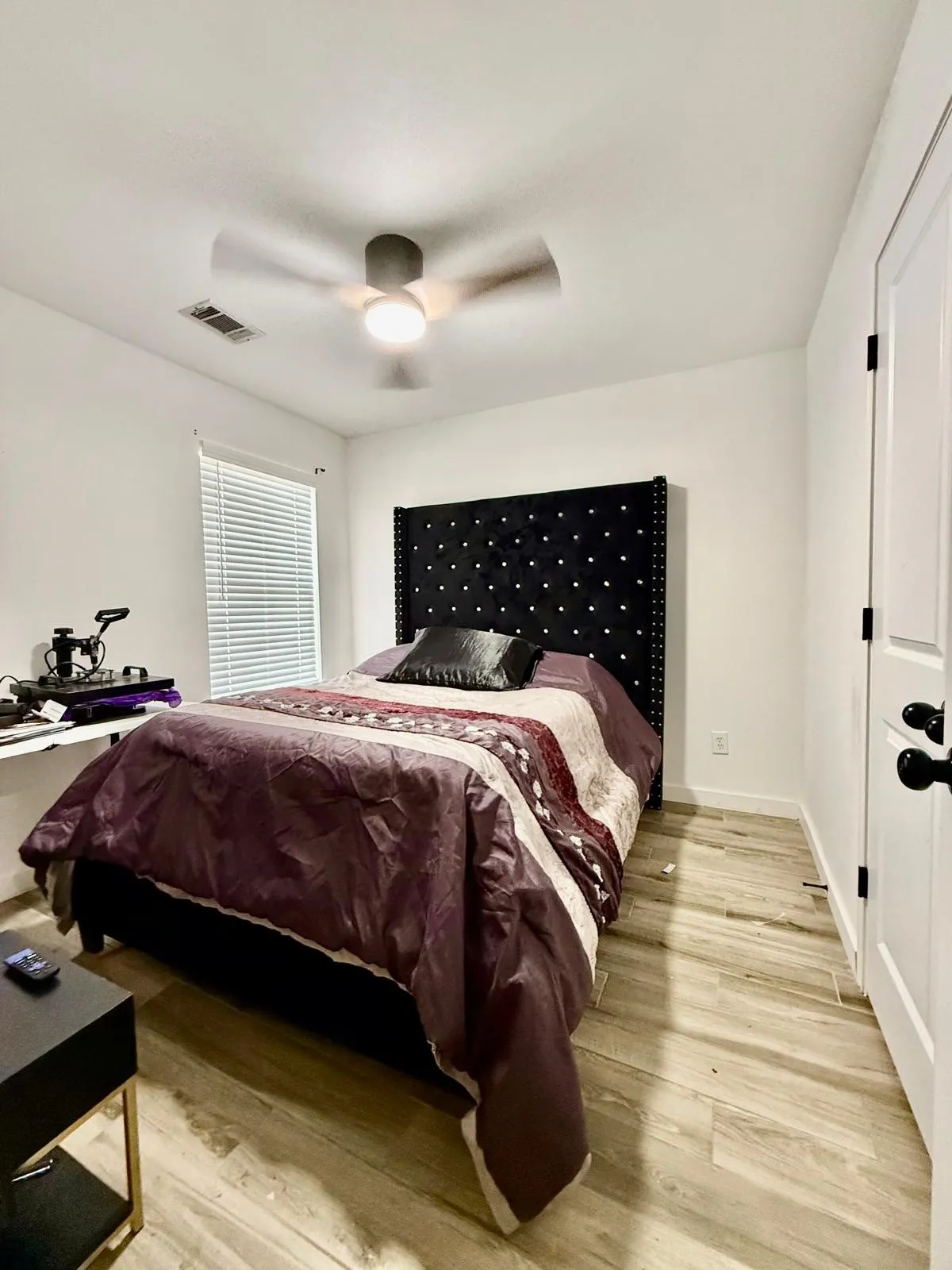 Recessed lighting, ceiling fan with integrated light, wood-finish flooring, white walls, and white door with black hardware