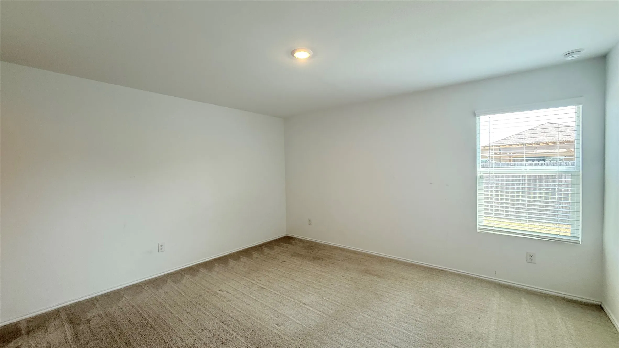 Recessed lighting, neutral wall finishes, carpet flooring, window with horizontal blinds