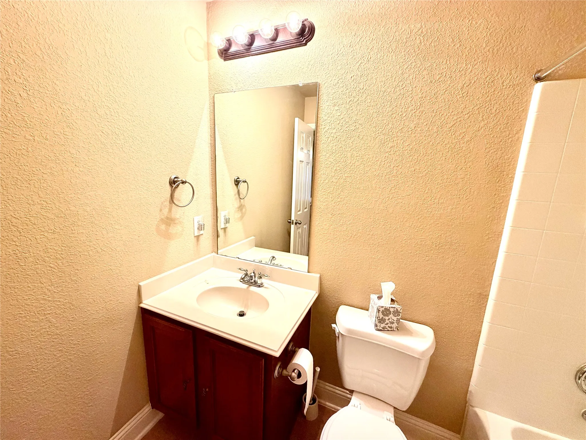 Vanity with white countertop, chrome faucet, and integrated sink