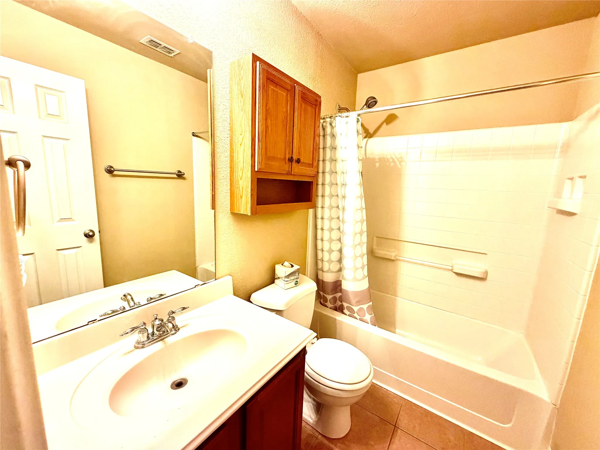 White vanity with integrated sink, chrome faucet, and rectangular mirror