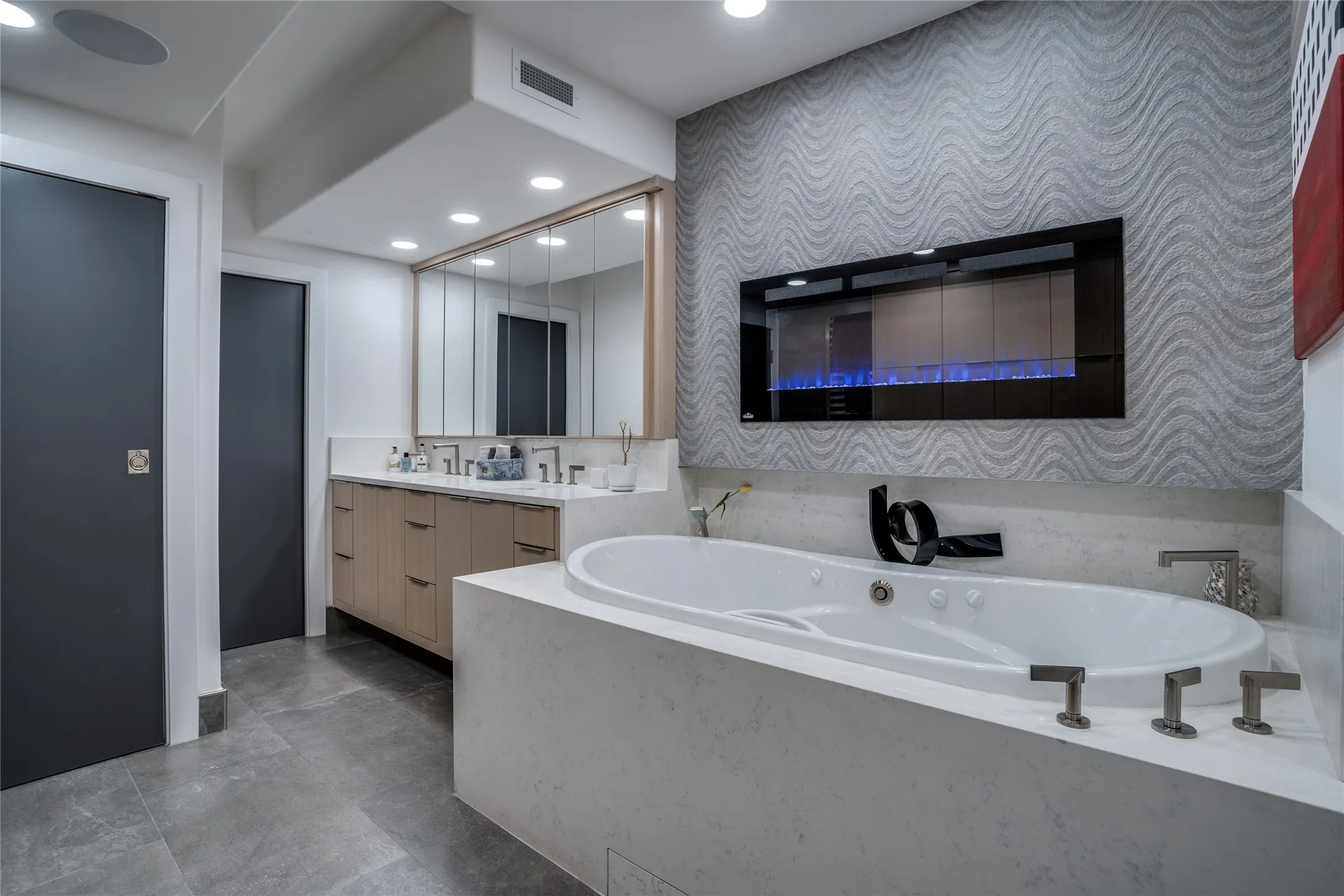 LED fireplace over tub in primary bath, floating vanity