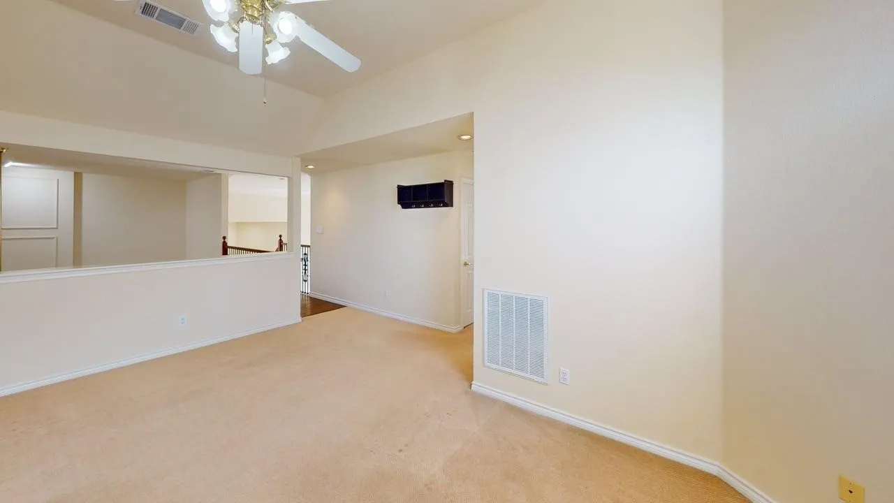 Vaulted ceiling, ceiling fan with integrated lighting, recessed lighting, and wall-to-wall carpeting
