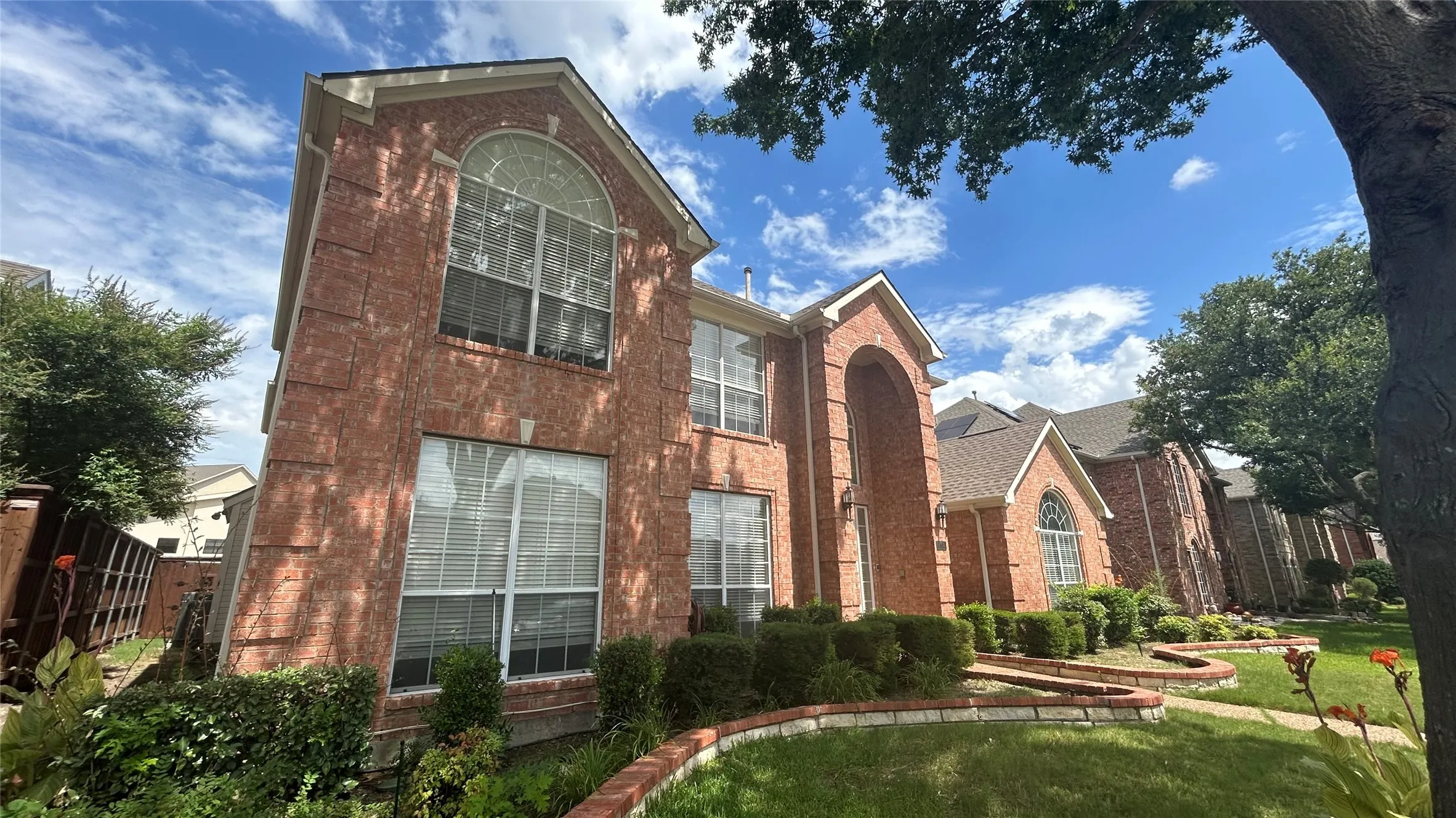 Brick exterior with multiple arched windows and a prominent arched entry