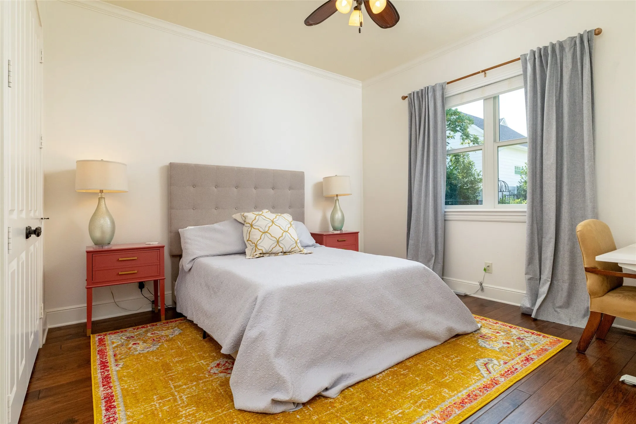 Hardwood flooring, crown molding, white trim, and a ceiling fan