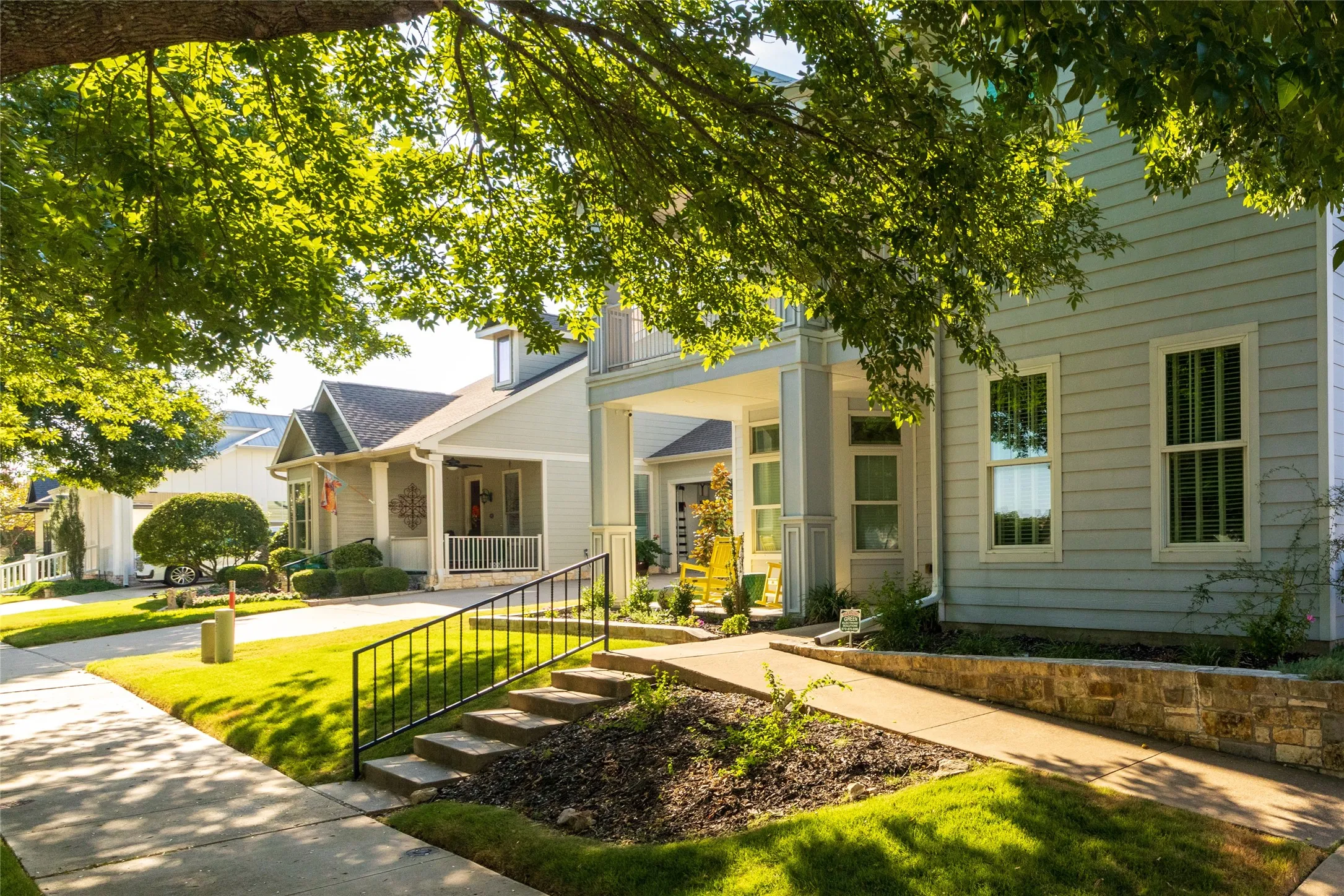 Light blue siding exterior with white trim windows and columns