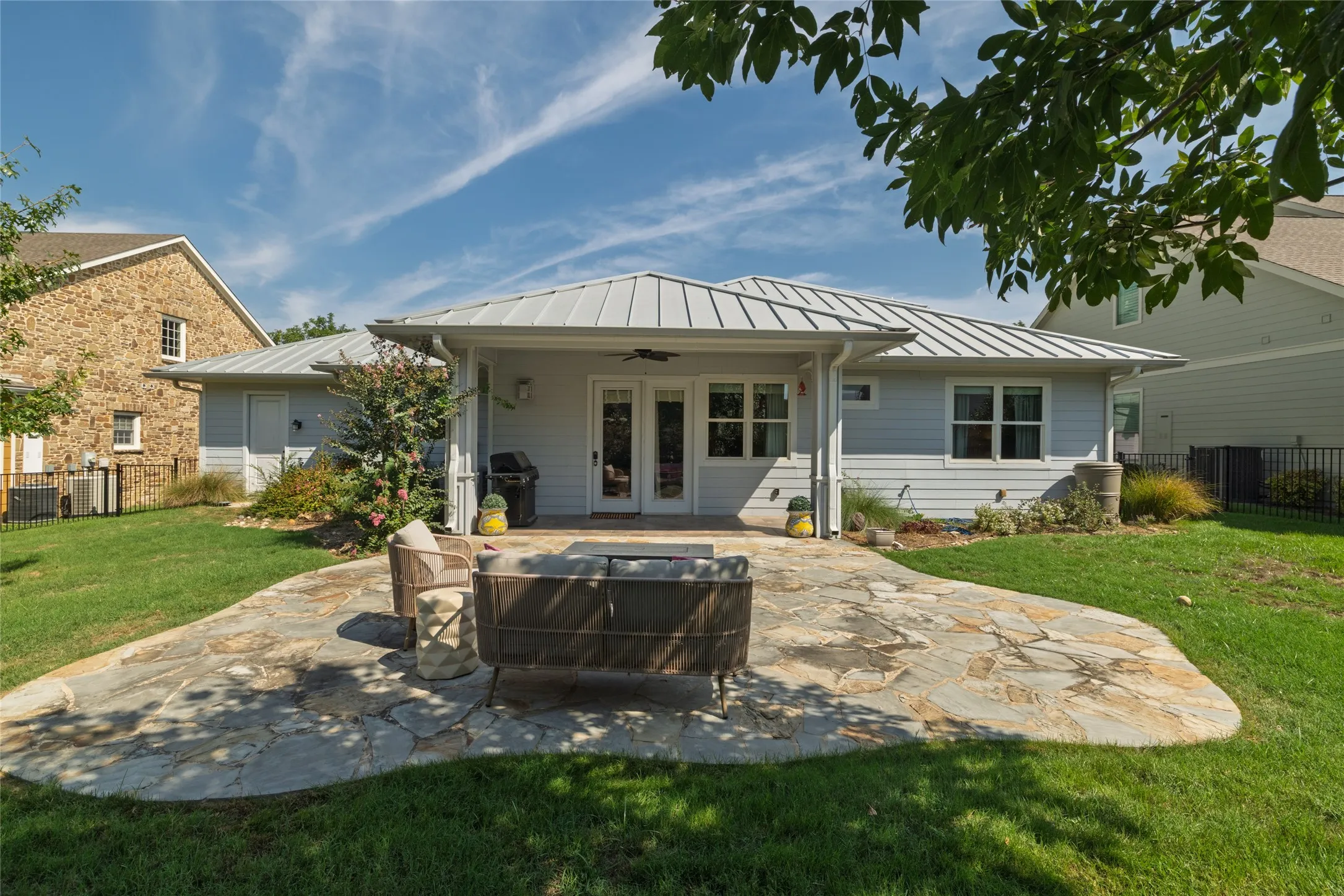 Expansive irregular-shaped flagstone patio with a direct entry to the home