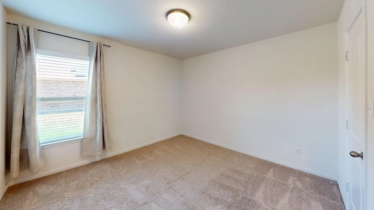 Wall-to-wall carpeting, single window with blinds, and flush mount lighting