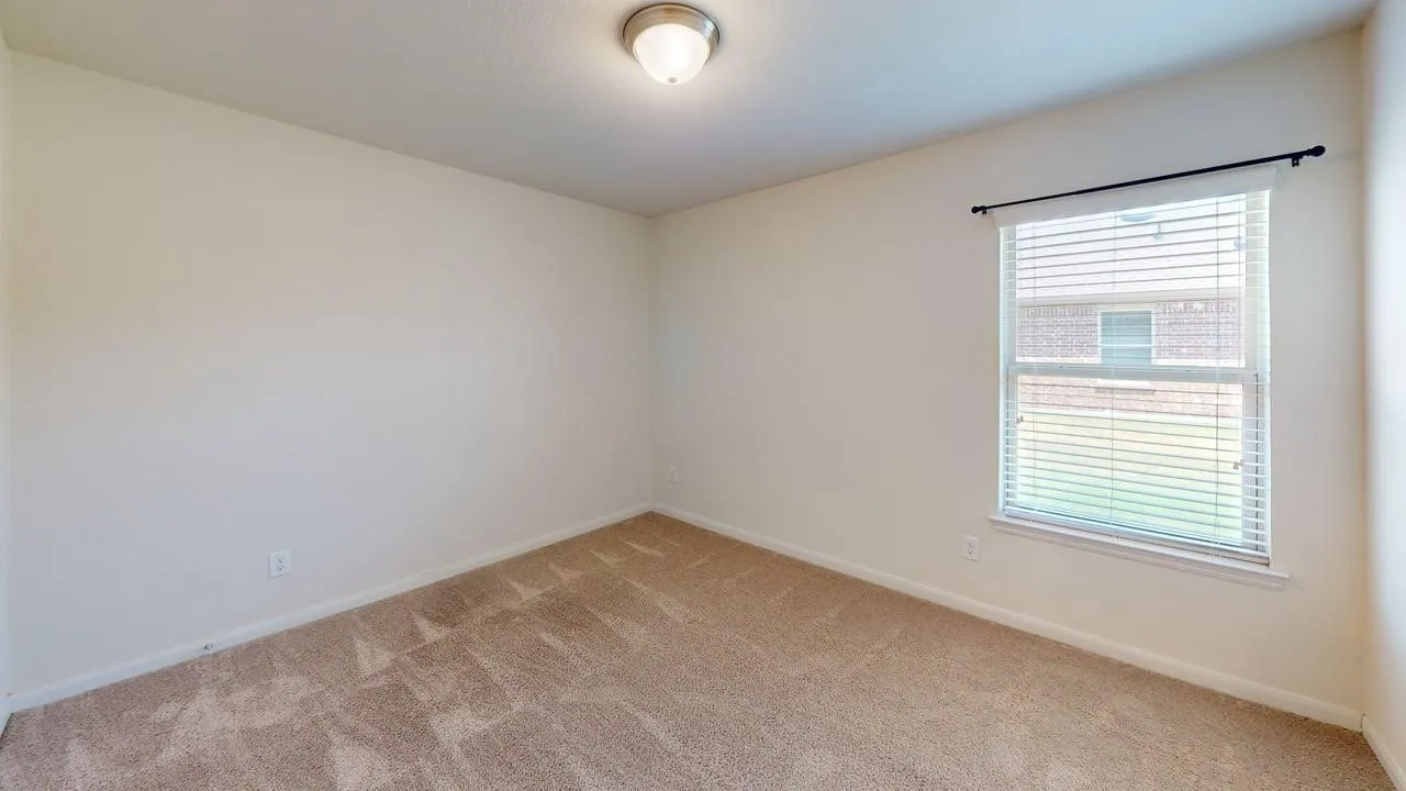 Light-colored walls, window with blinds, flush mount ceiling light, and carpeted flooring