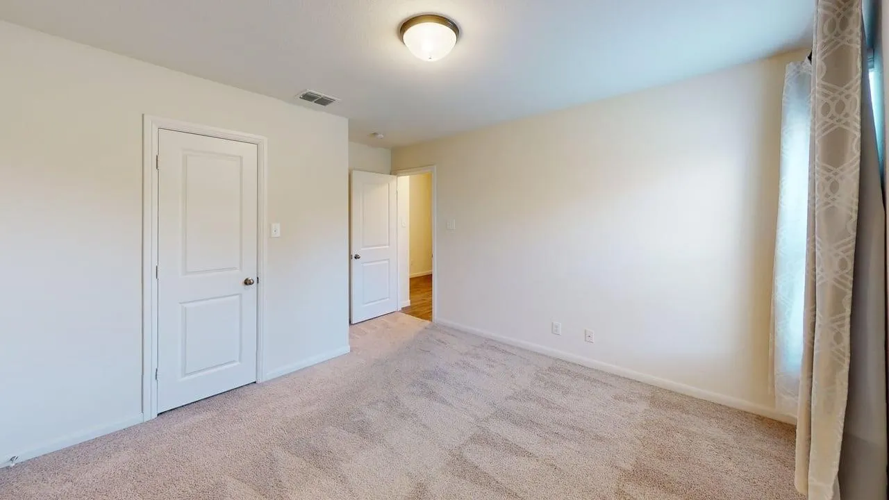 Light-toned wall paint and matching trim, neutral carpeting, and a ceiling-mounted light fixture