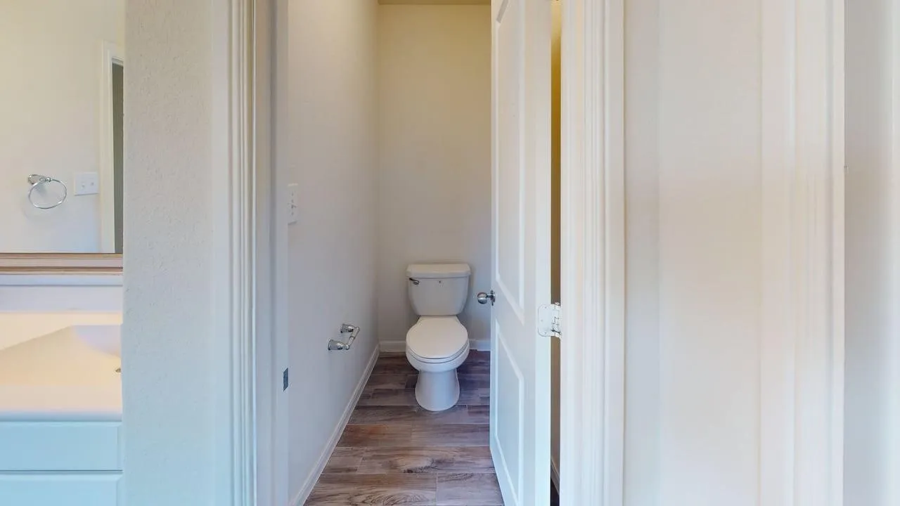 White toilet with chrome toilet paper holder