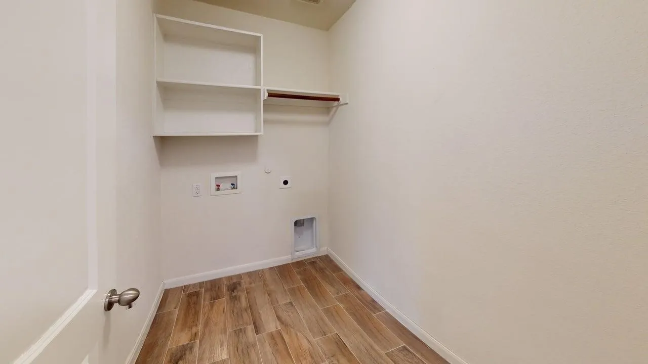 Built-in shelving, wood-finish flooring, and a clothing rod