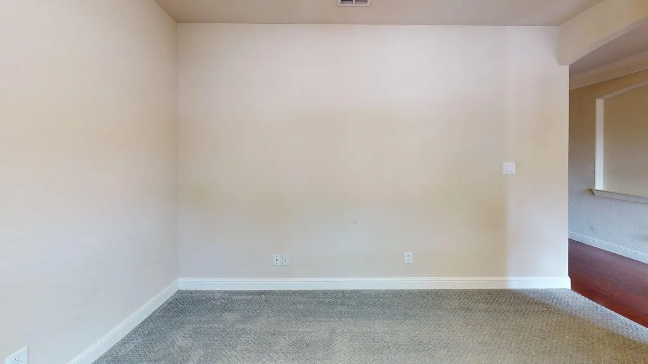 Carpeted flooring, light-toned wall paint, and white trim