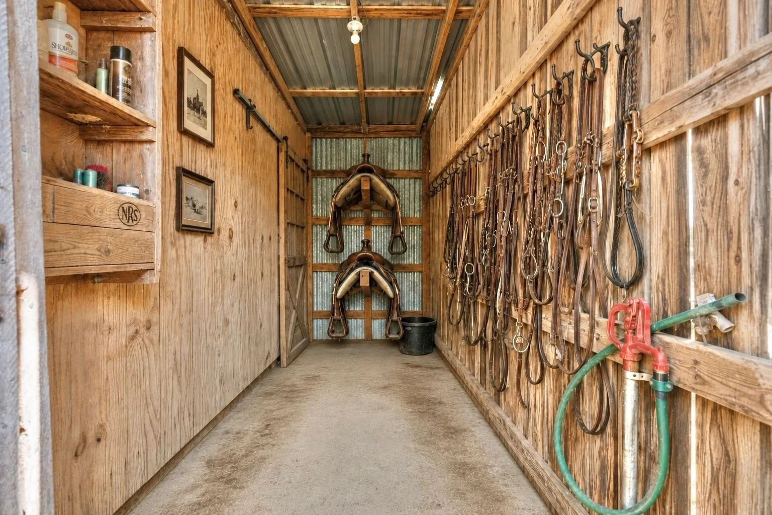 The tack/feed room is conveniently located to the right of the last stall in the barn. This also includes WATER!!
