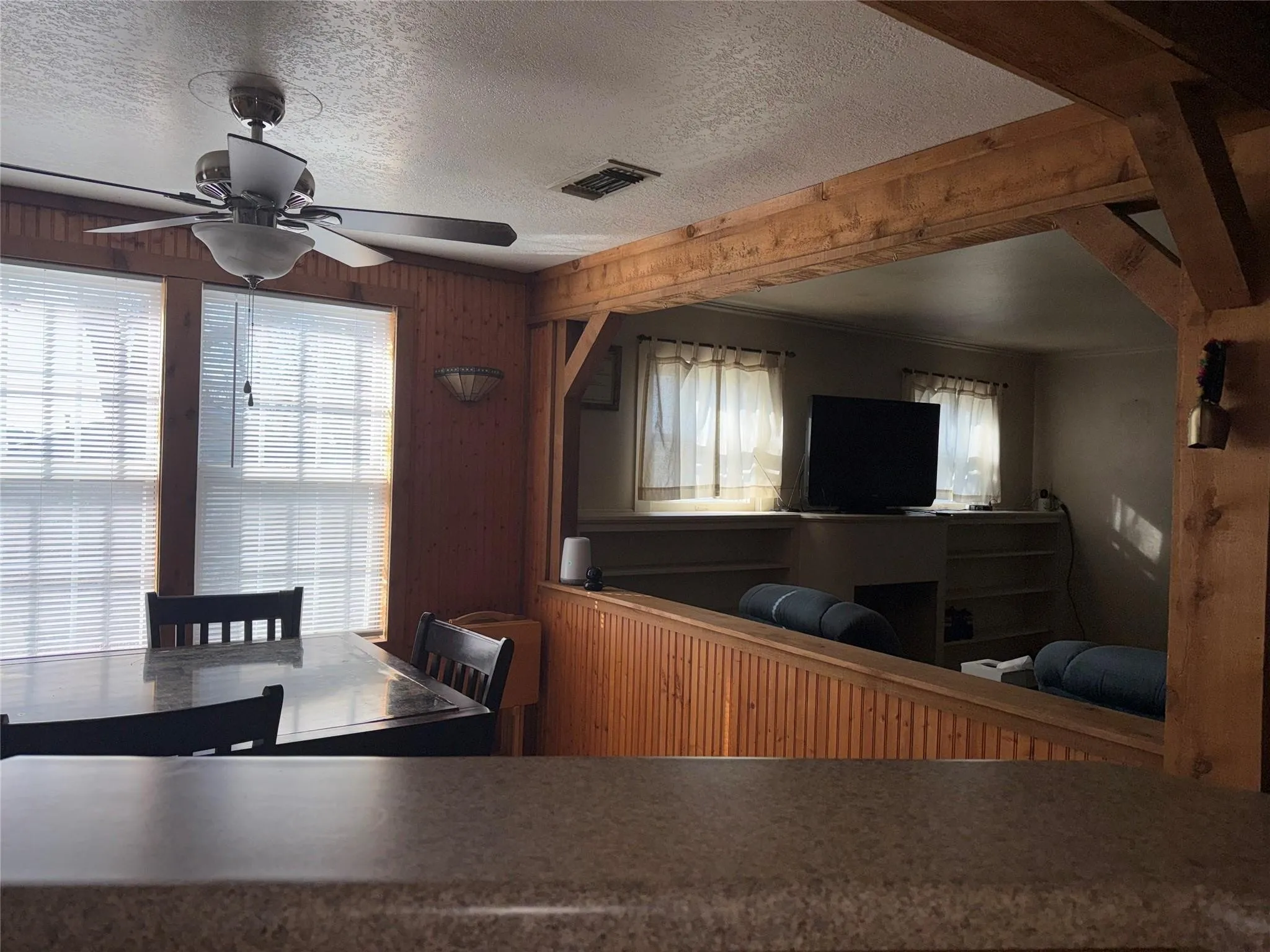 Wood-paneled walls with wood-finish ceiling beams