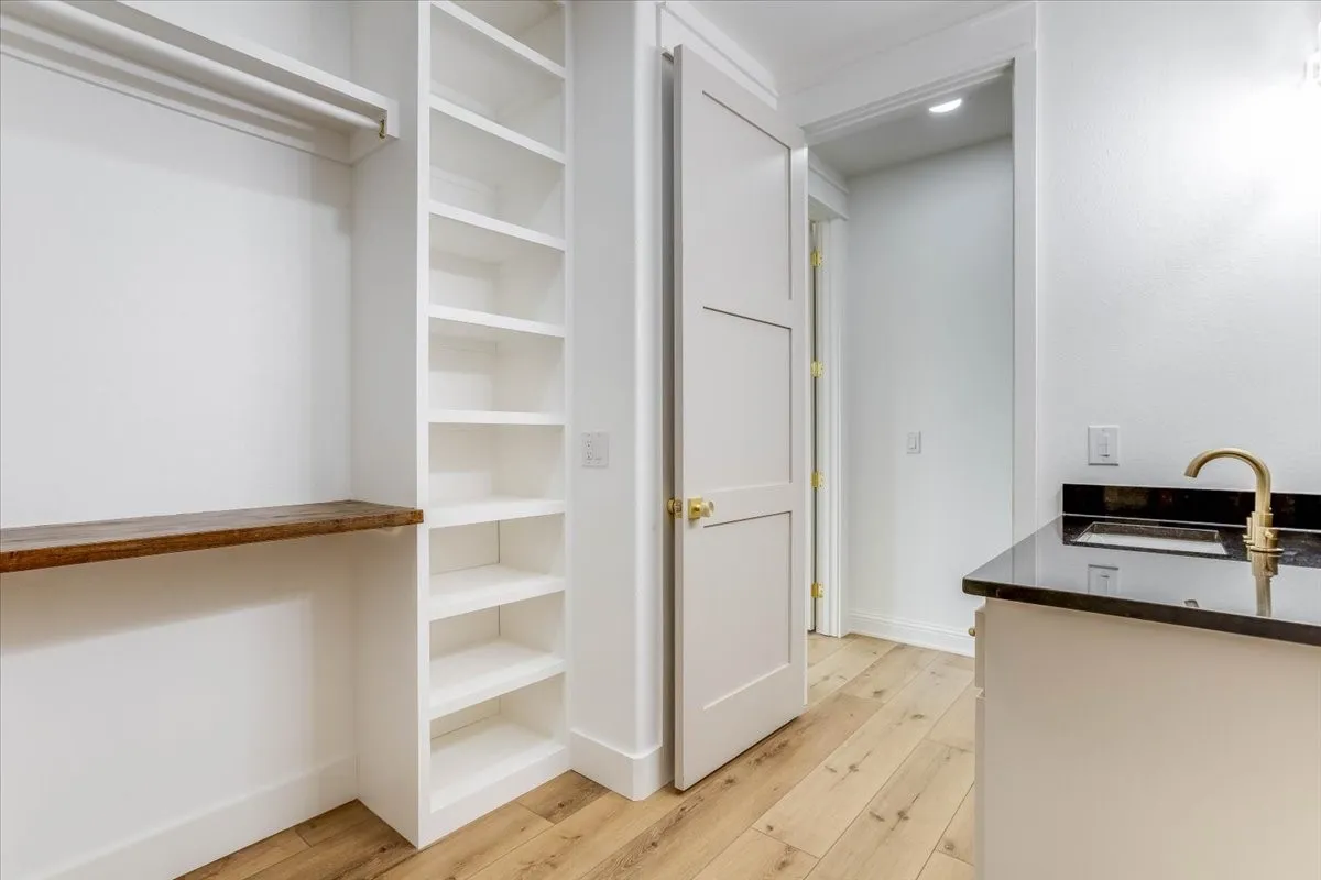 Sink, built-in cabinetry, walk-in closet, full size area for W/D