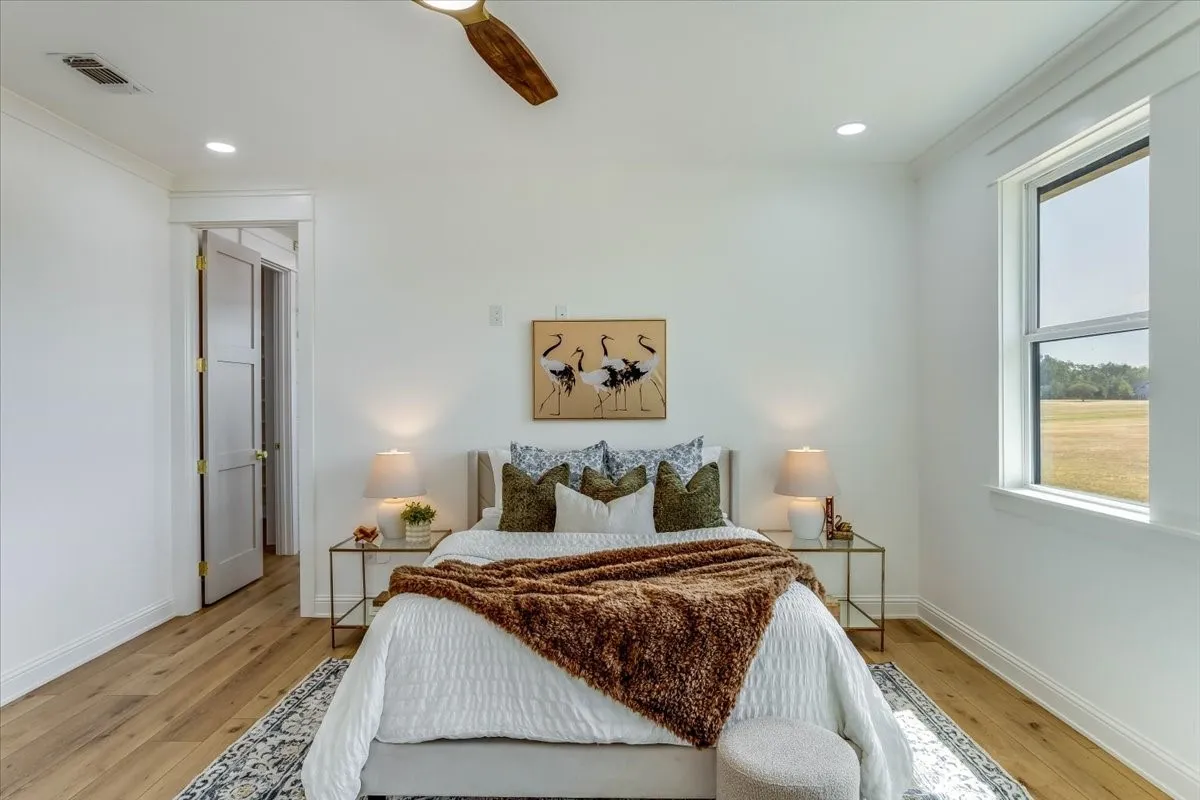 Recessed lighting, wood-finish flooring, and a ceiling fan with wood-finish blades