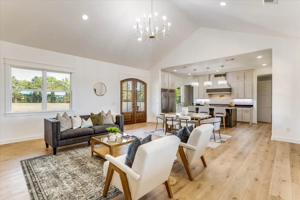 Spacious open-concept layout with vaulted ceilings and wood-finish flooring