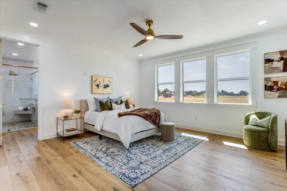 Hardwood-finish flooring, recessed lighting, and a ceiling fan with integrated lighting
