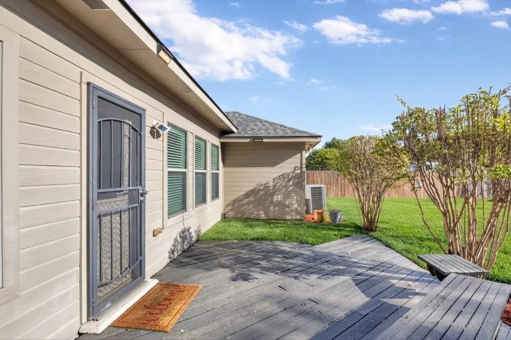Exterior siding with multiple windows and a security screen door