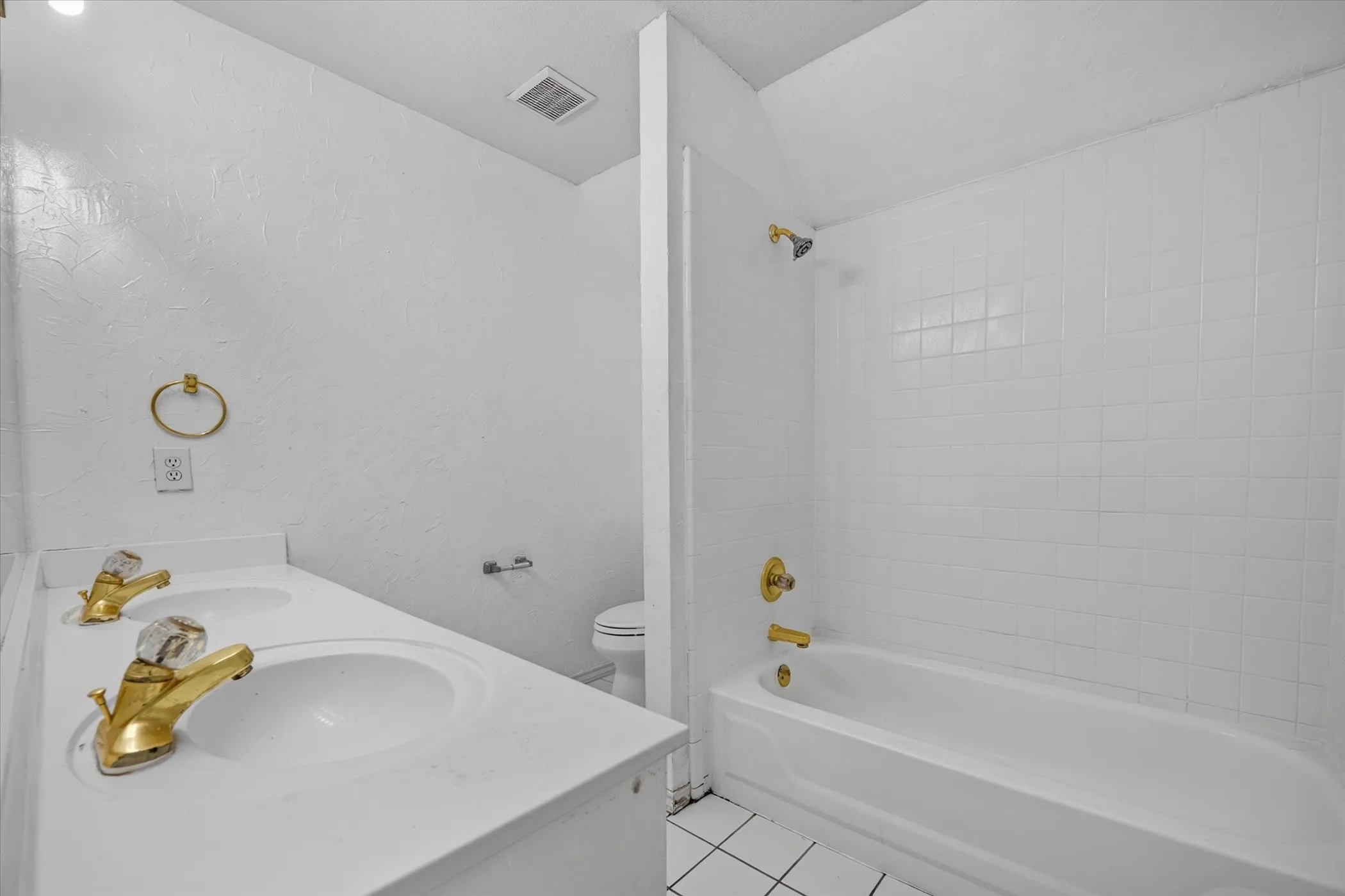 Dual vanity with integrated sinks and gold-tone faucets