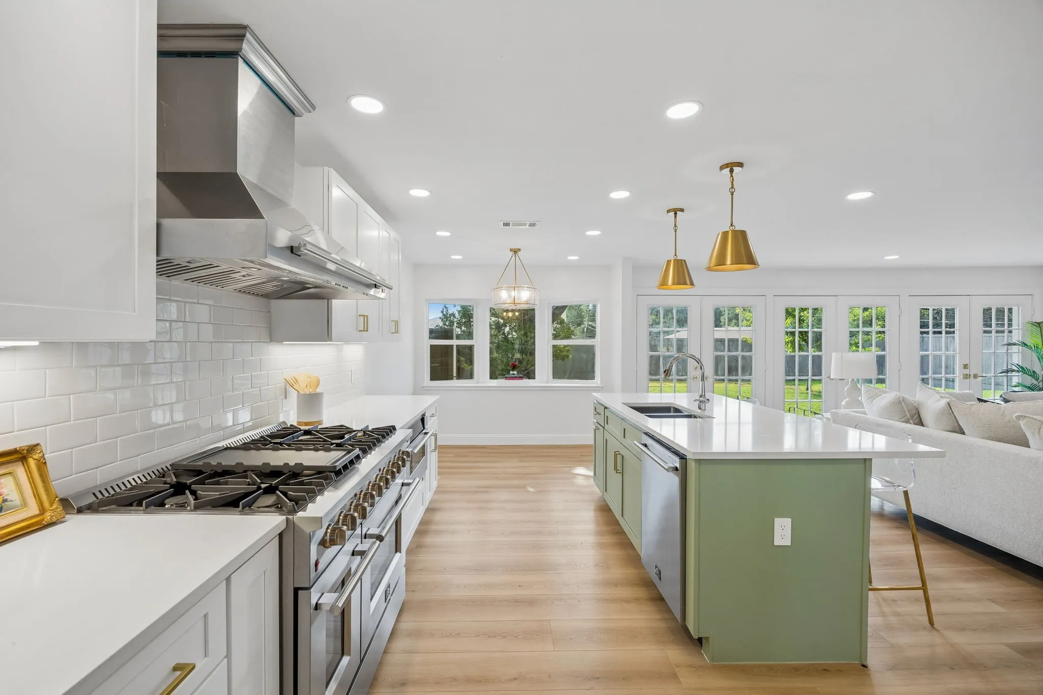 Updated kitchen with gas range, built in fridge and freezer, and quartz countertops throughout offer both style and function.