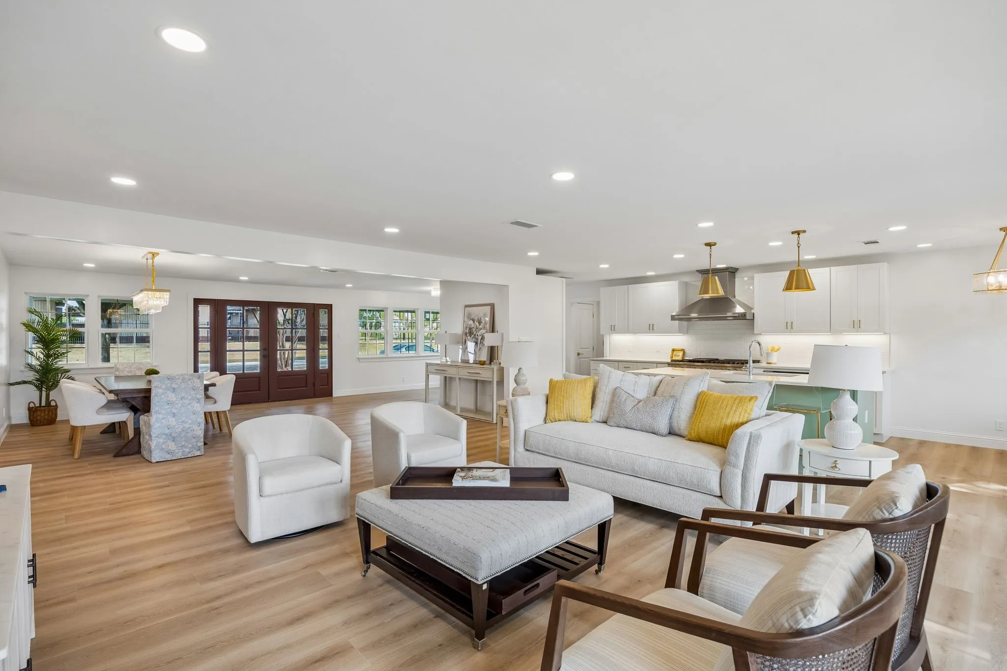 Expansive open-concept living and dining areas with LVT floors, recessed lighting and seamless flow into the updated kitchen.
