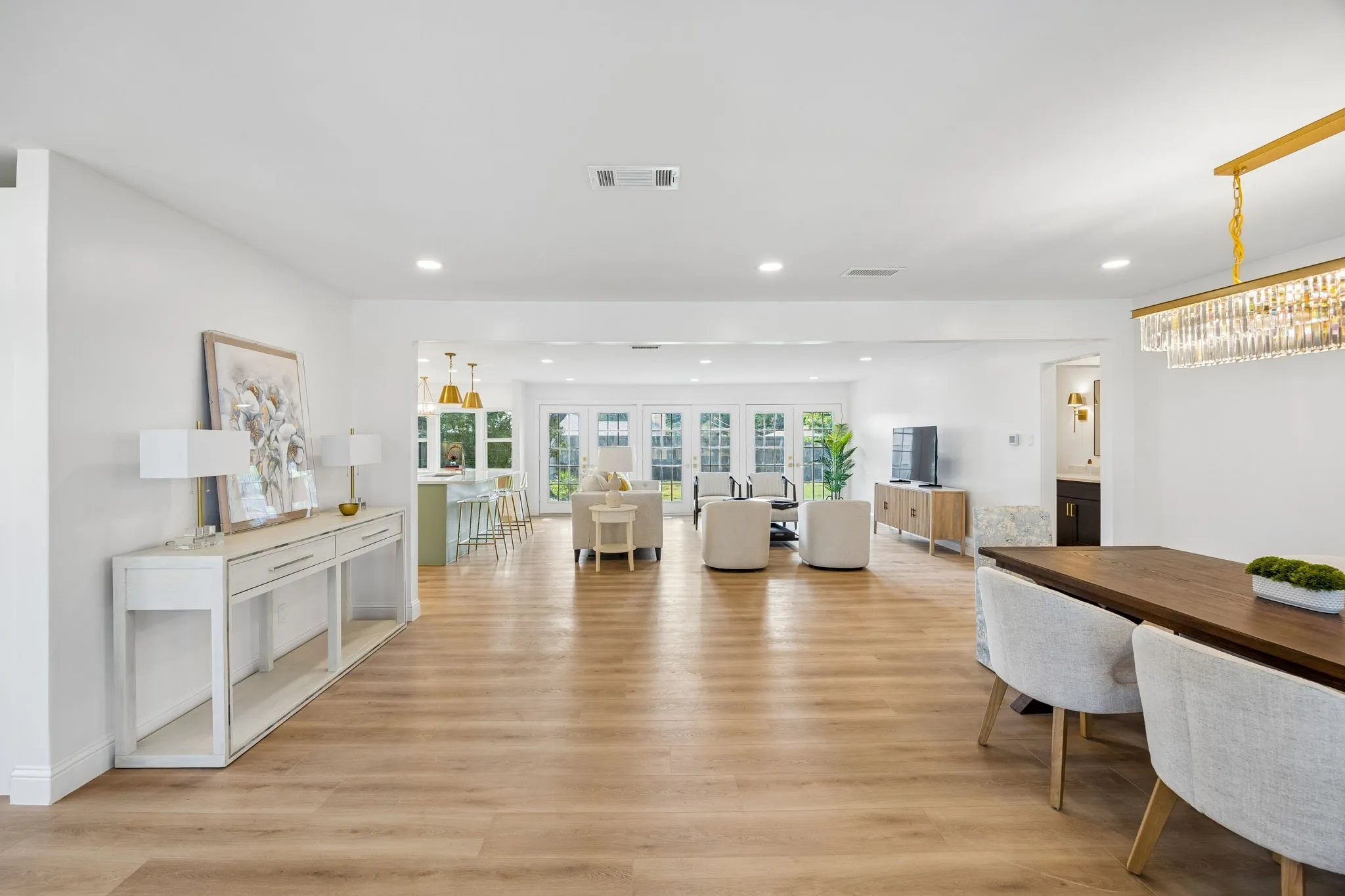 This open concept great room brings the kitchen, formal dining, breakfast nook, and living area together in one seamless flow. Wood flooring runs throughout, and a neutral color palette lets the space adapt to any style.