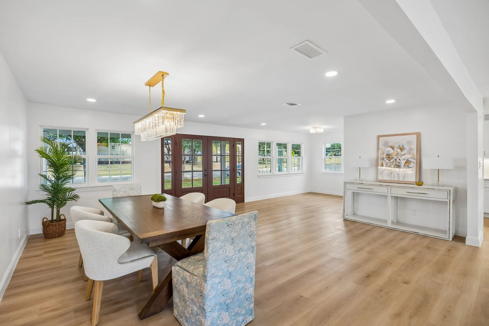 The formal dining room flows directly into a versatile adjoining space, ideal as a game room, study, or additional sitting area.