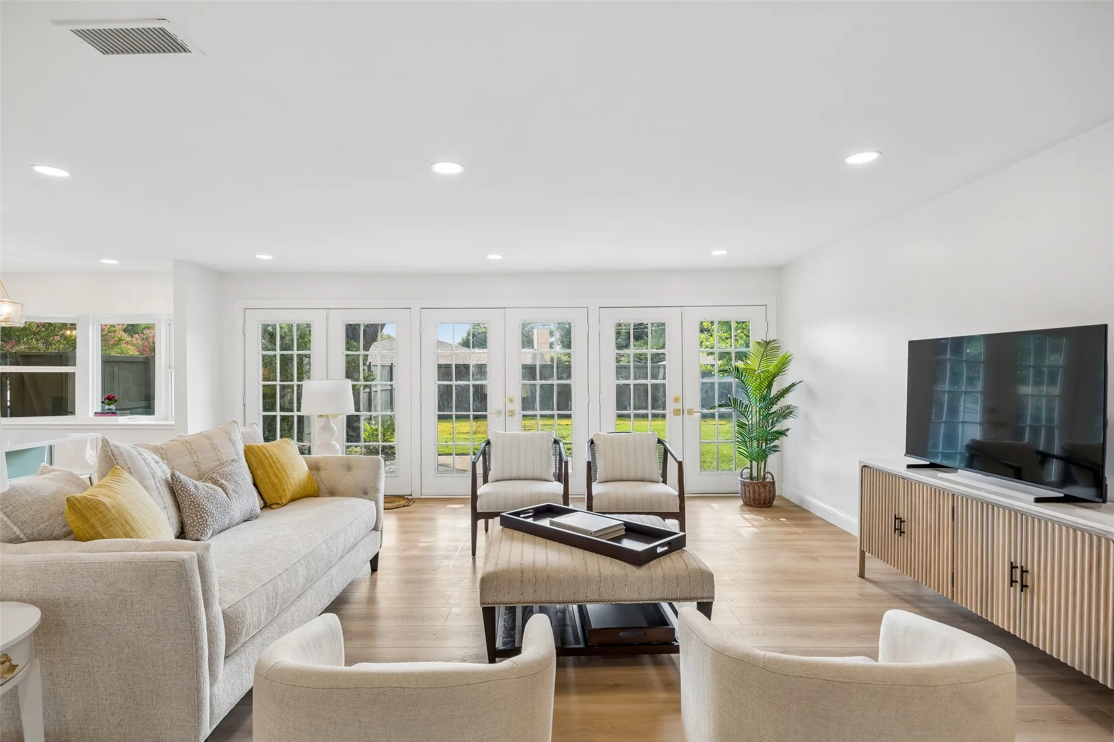 Spacious living area with french doors leading to the private backyard.