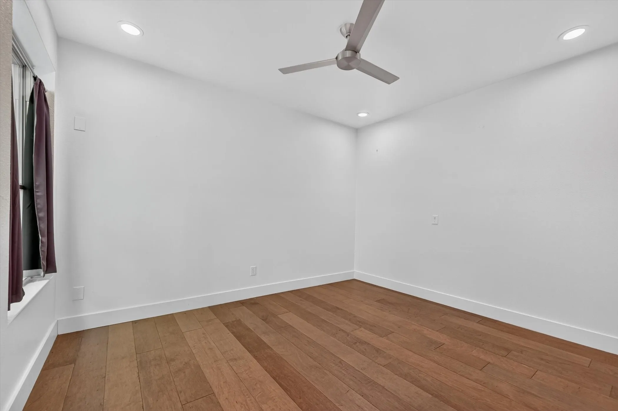 Recessed lighting, ceiling fan, wood-finish flooring, and white walls