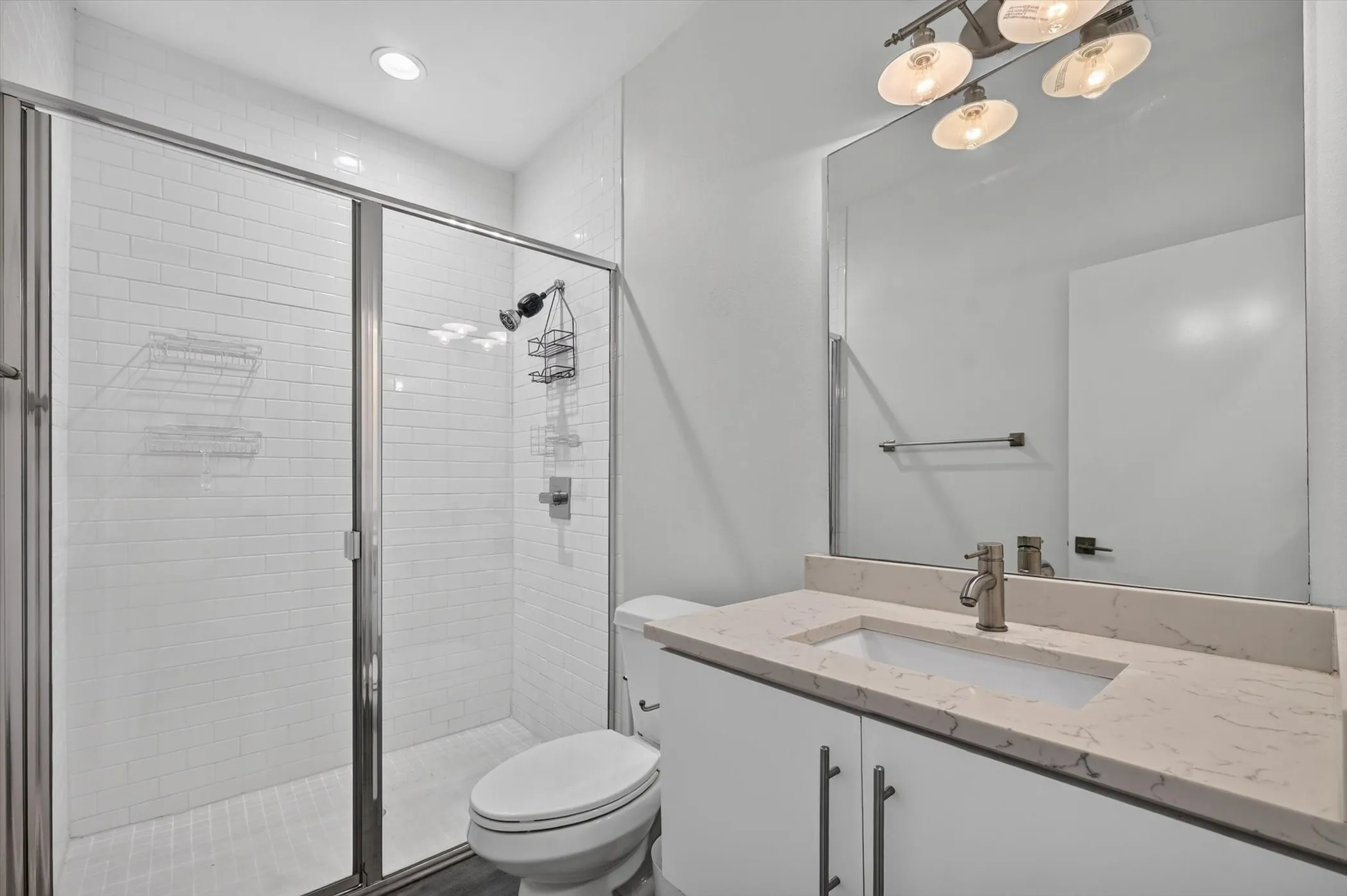 Shower with subway tile surround and glass enclosure