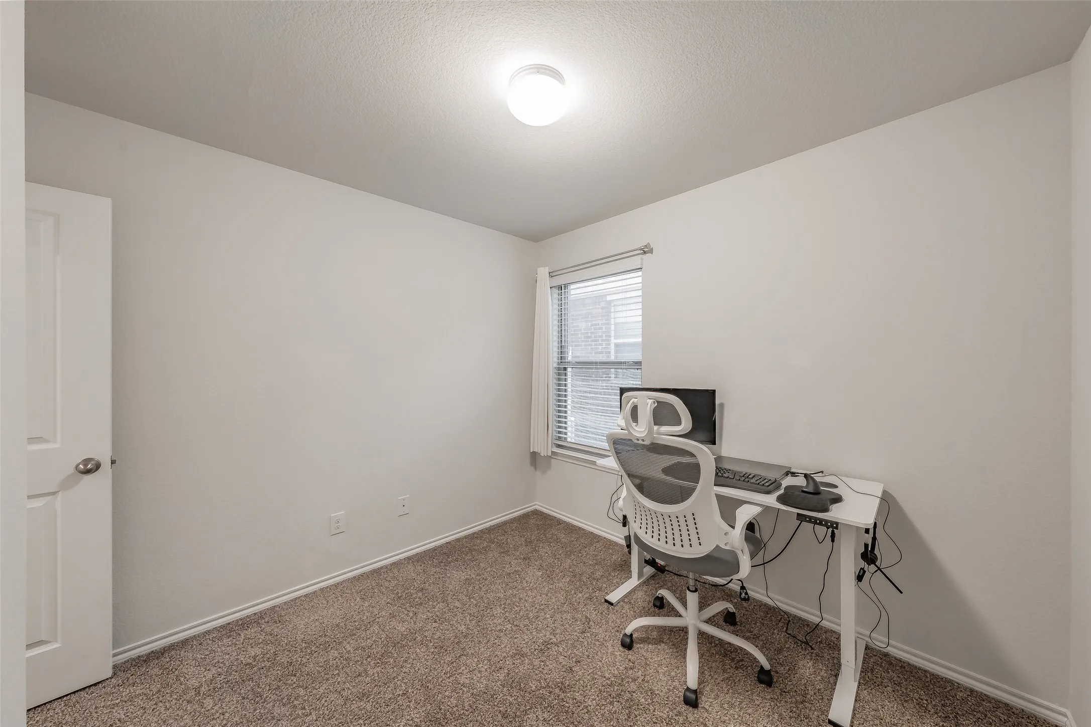 Neutral wall color with textured carpeting