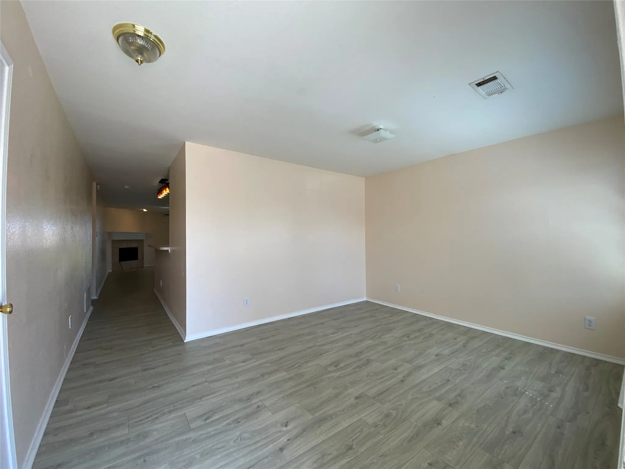 Unfurnished room featuring baseboards, visible vents, and wood finished floors